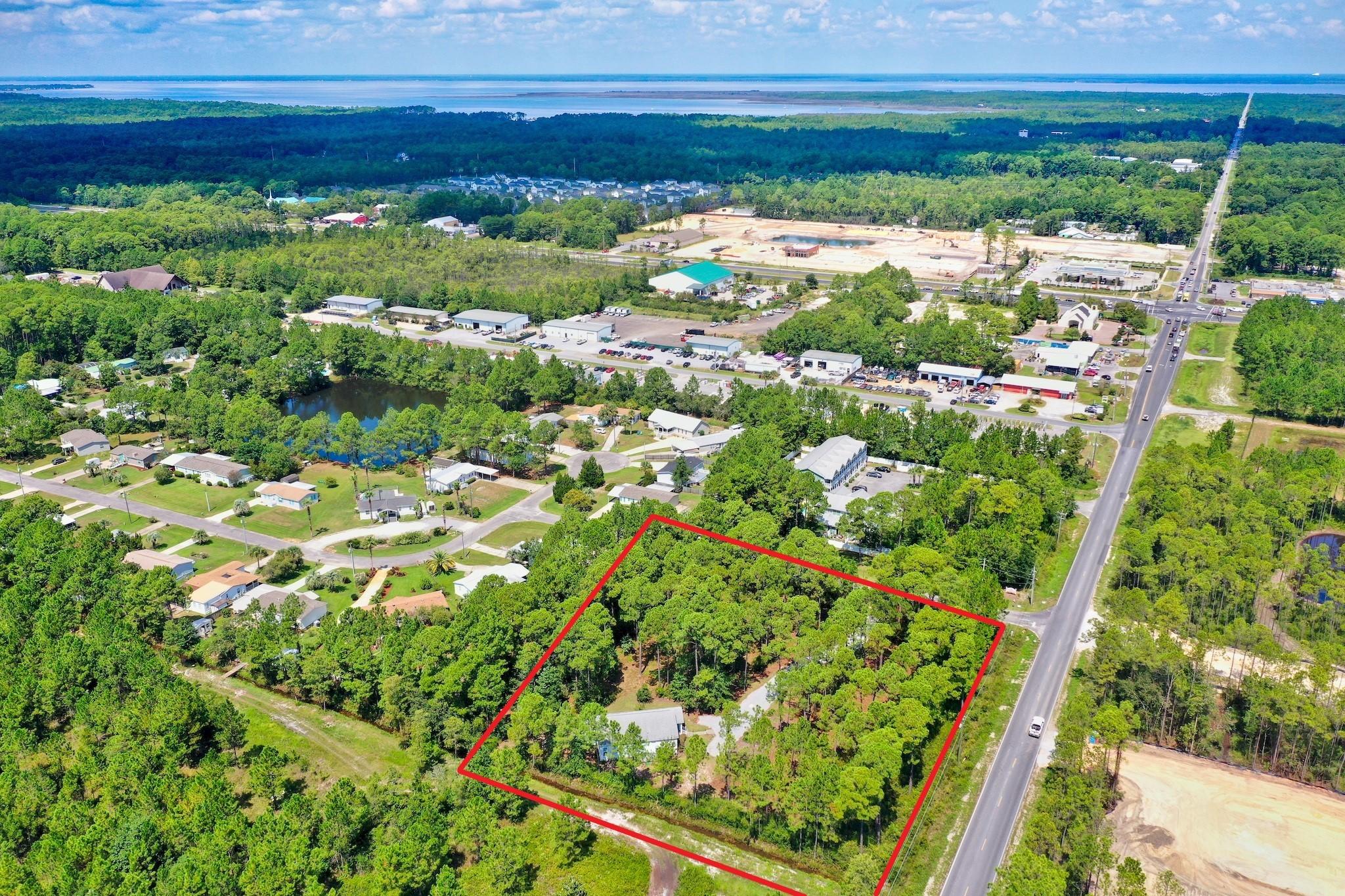 1.94 acres located in South Walton County just off US Hwy 98 on 393 South in 30A with beautiful, lush surroundings and endless opportunities! The property is zoned NPA Infill and is approved for residential or commercial use, which allows 8 units per acre of residential development as well as some neighborhood commercial use. With substantial commercial use along US Hwy 98, this property has great potential. Property consists of two parcels, one for the vacant land and one for the single family residence. 0.4 acres was cleared for a house that was built on the land in 2012. The house is also listed in MLS, please reference 831652. This is a great opportunity to own a nice size property in an excellent location between US Hwy 98 and Hwy 30A. This property has the luxury of privacy, yet you