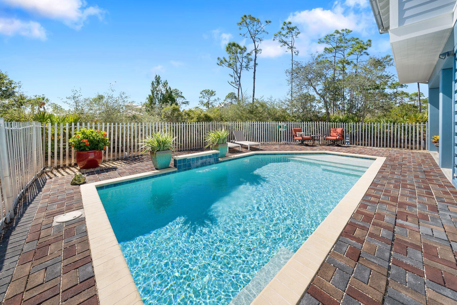 Nestled within the tranquil environs of Phase 1 of Windmark Beach in Port St. Joe, this distinguished residence is a testament to refined coastal living. Offering a grand expanse of more than 2,500 square feet, it epitomizes spaciousness and comfort. With three generously sized bedrooms and two-and-a-half bathrooms, it embodies the ideal family haven. Enveloped by a lush conservation area, this property affords unparalleled privacy and panoramic natural vistas. A captivating bay view graces this abode, complemented by a refreshing pool and the added convenience of an elevator. The living and dining areas, expansively appointed, beckon gatherings and entertainment, while the master bedroom, of impressive proportions, boasts an expansive walk-in closet.