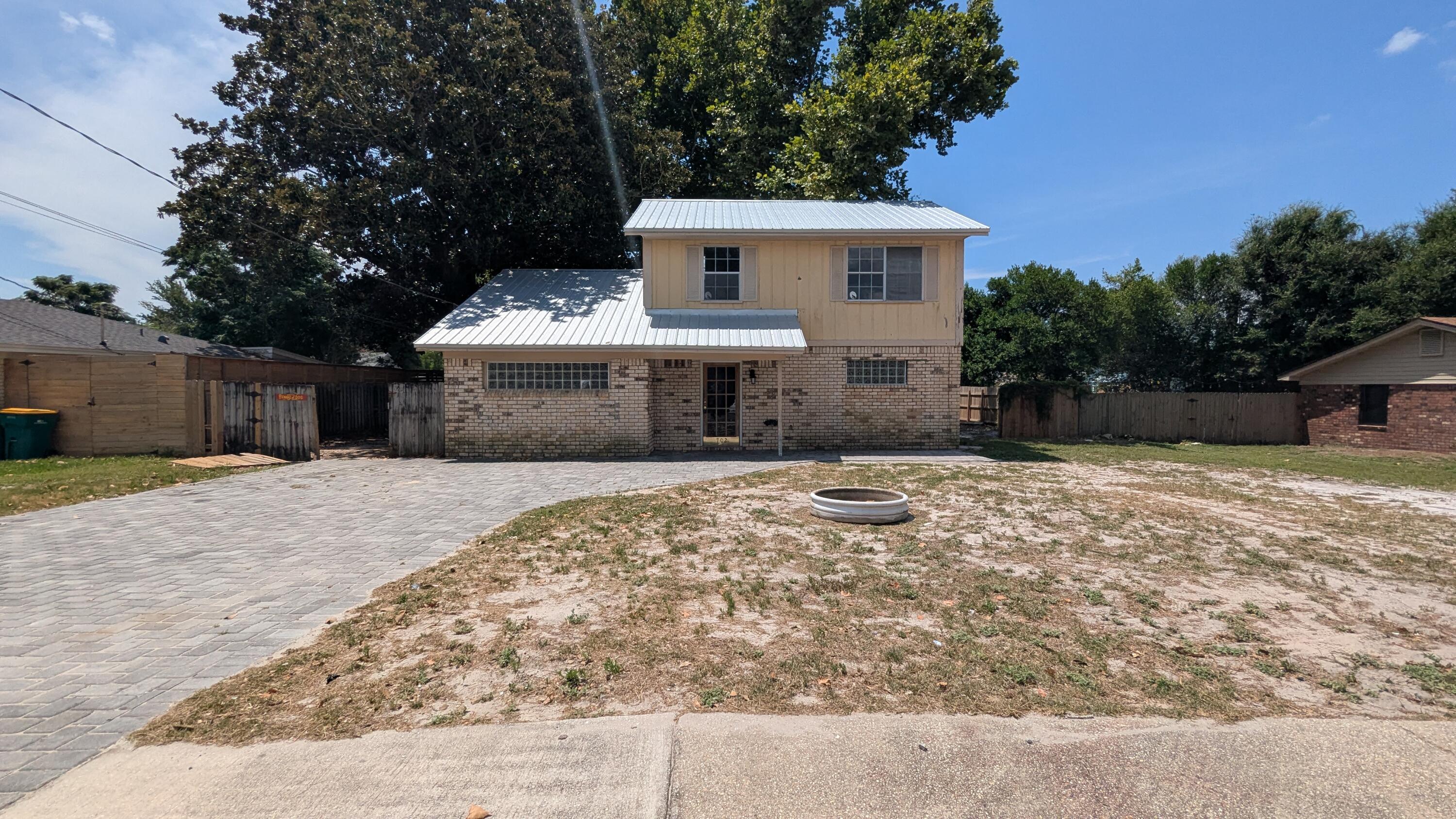 Welcome to this charming two-story home located in the vibrant city of Destin, FL. This property boasts three spacious bedrooms and 1.5 bathrooms, providing ample space for comfortable living. The kitchen is equipped with practical laminate countertops and washer/dryer hook-ups, offering convenience for your everyday needs. The exterior of the house is adorned with sturdy brick siding and a metal roof. The paved driveway adds to the overall appeal and functionality of the property. This property is distressed and in need of updates and some TLC, but at an affordable price, this adorable property would make an excellent investment property or first-time home. Vacant and easy to show.