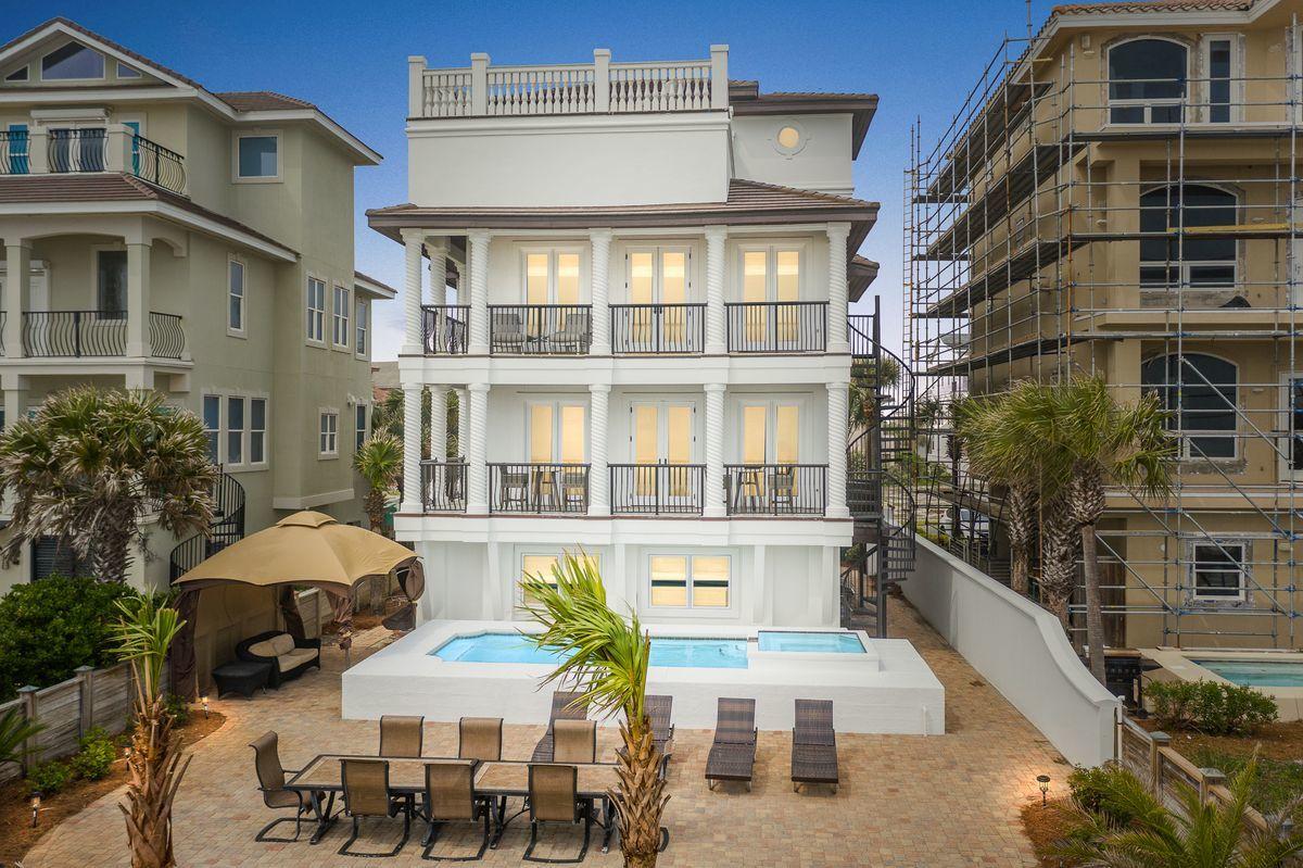 Pristine gulf vistas accentuating a prominent beach front positioning in the heart of Destin Florida characterize this sprawling four story gulf front retreat in the gated neighborhood of Dunes of Destin. Newly remodeled and beautifully decorated, this masterful coastal retreat has been completely refreshed and amenitized with notable features including a large gulf front pool and private beach walkover as well as a fourth story entertaining deck offering panoramic views over the emerald green waters and white sand beaches of the Gulf of Mexico.