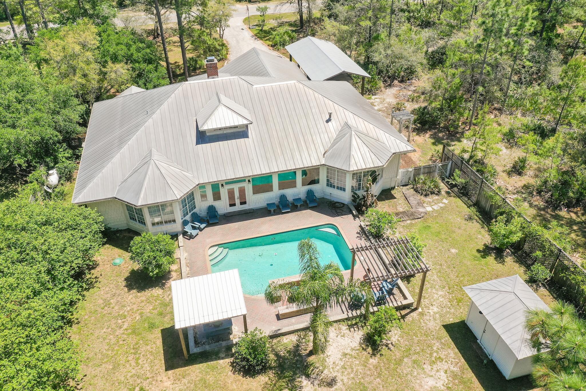 Yes, you can have it ALL and there are even more than 7 listed reasons for this to be Yours! Second owner custom built homestead with TWO homes, large workshop, endless storage, RV parking and MORE located in Woodland Bayou Estates. #1 - Main single story home with a beautiful soaring 22' ceiling entrance, solid red oak flooring throughout most of the home, eat in kitchen plus a separate dining area, sitting room/office separated by a gas stove with a desk nook & a closet, stepdown family room with custom mantle above the wood burning fireplace, heated and cooled sunroom with a 1/2 bathroom overlooks the pool , ''your'' large bedroom has bay windows overlooking the back yard, bathroom with two vanities, soaking tub and a two person shower, ''their'' two bedrooms share a full bathroom.
