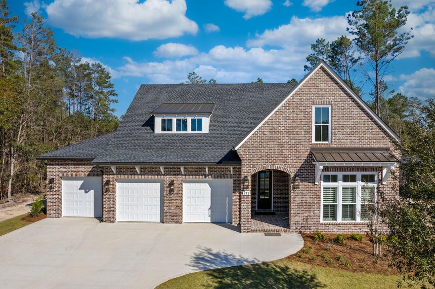Rare opportunity!!!  Lake View!! New home by locally renowned builder in Gated neighborhood in Hammock Bay.  Yard features custom pool and unbelievable landscaping.  Large covered rear porch with stained cypress ceiling and full summer kitchen.  Interior features built in shelving in the foyer and living room.  Wood floors throughout.  10' ceilings and 8' solid core doors throughout.  Upgraded lighting package.  Interior brick accents.  Custom master closet built ins.  Brick fireplace and reclaimed wood mantle in living room.  Kitchen features furniture grade cabinets to ceiling, Cambria quartz counter tops and full Cambria quartz backsplash.  Back kitchen with ice maker and sink and built in cabinets.  Study with built in shelves.  Huge game room and walk out storage.  3 car garage