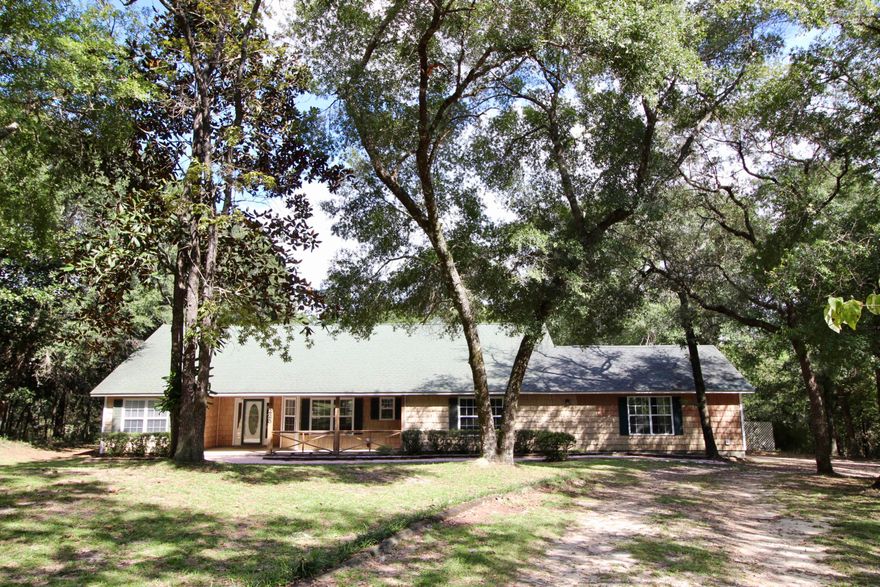 Super private lakehouse - in a restricted community - and located on 1 acre at the end of the road (with only one neighboring home)! Priced RIGHT! Gorgeous shaded lot with hardwoods and a gentle slope to the water. Inside you'll find a split plan with hardwood, tile & carpet in the bedrooms & den. HVAC only 1 yr old! Vaulted ceilings in living & master bedroom. There are TWO utility rooms and an extra large den/multi-purpose room that could be a bedroom/music room/workout/home office - your imagination is your only limitation. Back screened porch overlooking the lake - also handicap ready w/ exterior ramps! Covered front porch and 2 car garage as well. You may choose to do some cosmetic updatesto make it yours and is priced accordingly. Otherwise the home is clean & ready to move into!