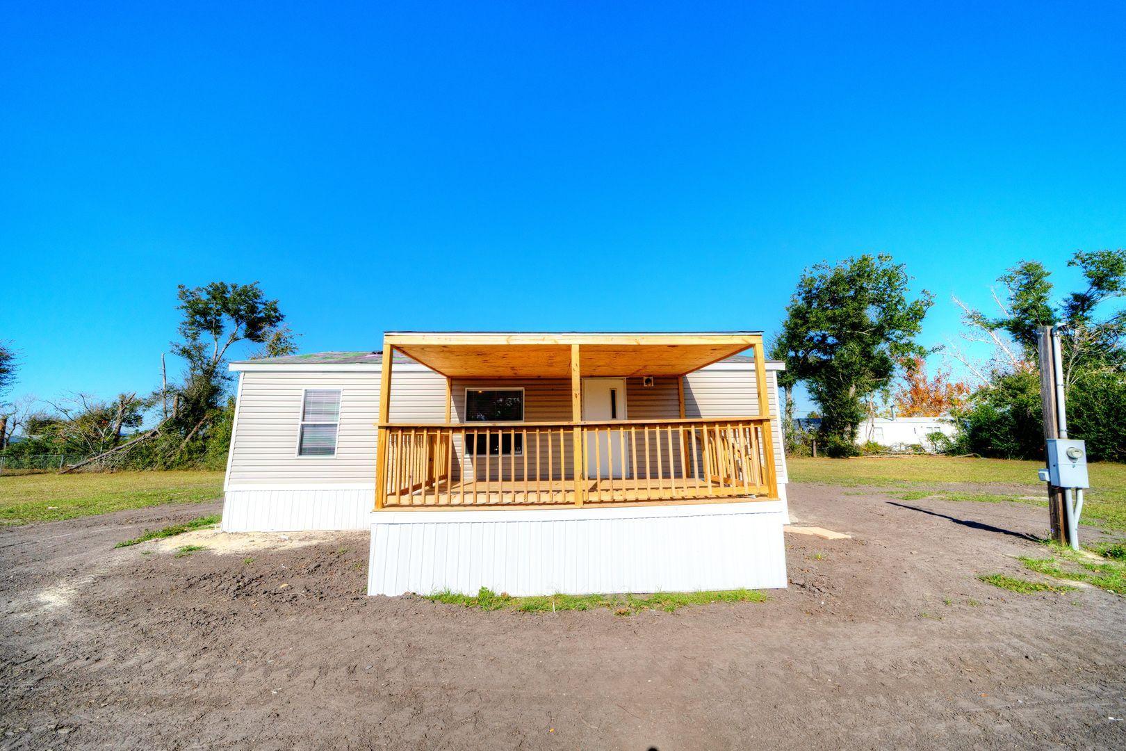 2 bed, 2 bath double wide on an oversized lot near TAFB. This home is welcoming with a new covered front porch and plenty of space for your landscaping dreams. This home features a split bedroom floor plan, offering plenty of privacy when hosting family or friends. The kitchen features a new stove and plenty of cabinet space for storage. The master bedroom is spacious with a private ensuite. The private master bathroom features a shower/tub combo and walk-in closet. The guest bedroom is spacious and has a private en suite. The guest bathroom also features a shower/tub combo. The Westerly 75 feet of this lot will not be included in the sale. The lot size being sold is 125x75
