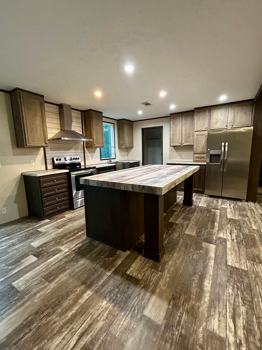 *Professional pics coming soon* Beautiful home on over 10.5 acres - Do you want seclusion in a country setting while still within close proximately to town? Do you have a need or want for a large pole-barn? This home & property might be just what you've been waiting for. This Move-In-Ready 3 bedroom, 2 bathroom home was built in 2022 and sits on a little over 10.5 acres. The kitchen features stainless steel appliances and a large island with plenty of cabinets! Linoleum flooring throughout the main living areas and bathrooms make for an clean flow with carpet in bedrooms for comfort. The main bathroom has a double-vanity with a large walk-in tile shower. The highlight is the stainless steel shower tower that features a rainfall shower head and massaging spray jets. On the opposite end of the home, you can find the other 2 bedrooms and bathroom with shower/tub combo. Outside, the beauty awaits. With a portion of the acreage cleared, there is still a large amount of the land that is wooded to help keep the home in its own little private sector. The pole-barn is located far enough away from the home that while the busy-body is outside piddling, the home-body can enjoy peace and quiet inside without being disturbed. There's not a neighbor in sight and only 1 other home located on this same road. Don't miss your chance to see this one in person! Located south of I-10, this property is still close to town while having an easy drive to Freeport or the south end as well. (this property also has a 2 bedroom, 1 bathroom, 1989 mobile home, that needs lots of TLC. We have given it no value. It needs a lot of attention but could be renovated for a second home).