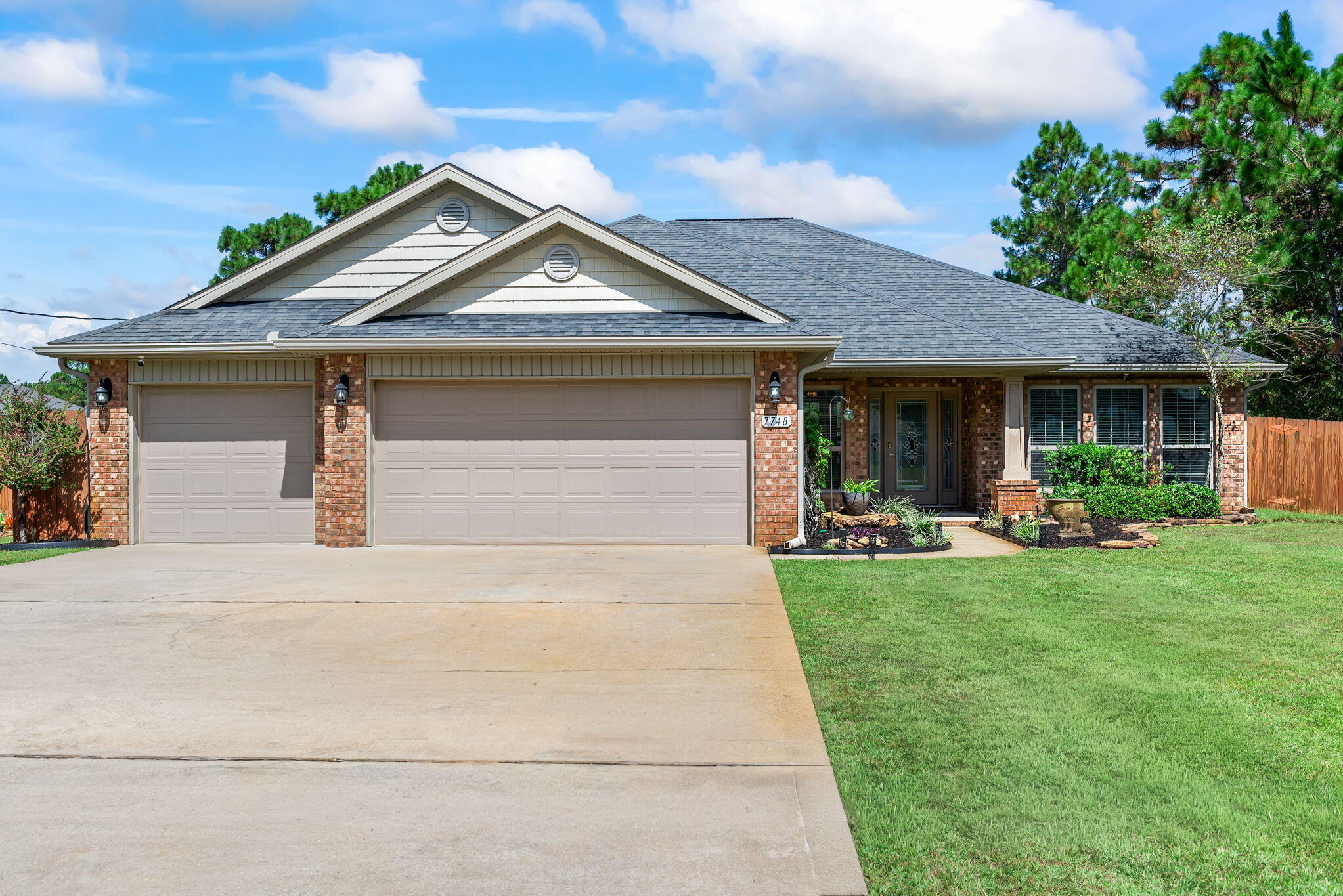 This beautifully designed 4-bdrm, 3-bthrm home offers the perfect blend of comfort and versatility and is exceptionally located on a quiet dead-end street in the desirable Holley By The Sea community. This plan features an open spacious main living room, dedicated dining area, a roomy breakfast nook, an office/sitting room and a Florida room with countless other possibilities. The kitchen has attractive granite countertops, an island with breakfast bar seating, pantry, and a new dishwasher. This split bedroom plan allows for additional privacy in the primary suite, which includes a luxurious walk-in tiled shower and two walk-in closets. The outdoor space is just as impressive with a large covered patio that has been extended creating the perfect sitting area for relaxing in the evenings. There is plenty of room on this large 1/2-acre lot for a future pool and entertaining is made simple with direct access to a bathroom from the patio. Additional highlights include front and rear rain gutters, a huge 12' x 25' workshop/garage with loft storage, wood privacy fence and Florida style landscaping. Holley By The Sea, residents enjoy access to multiple pools, a recreation center, workout facility, pickleball courts, sauna, waterfront access, a boat launch and more. This neighborhood offers not just a home, but a true lifestyle.