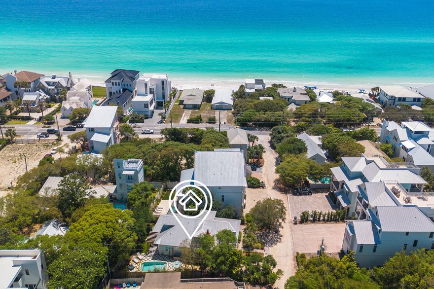 Welcome to 50 Camellia Street -- a home where Southern charm meets coastal living in the heart of Old Seagrove Beach, just a bike ride from the energy of Seaside and WaterColor and just steps to the serenity of the Gulf. This property is a custom-crafted Southern Living plan, built by renowned 30A builder Mark Bakane. This refined coastal retreat seamlessly blends notes of timeless lowcountry architectural features with relaxed beachside elegance.From the moment you arrive, the home's craftsmanship is evident. Inviting expansive front porches, natural wood accents and exterior gas lanterns illuminate the exterior beauty of this home. Step onto the storybook front porch where timeless Southern charm meets laid-back coastal luxury. Framed by classic shutters and natural wood elements this space offers a private, breezy retreat perfect for morning coffee or evening cocktails. Tongue-and-groove ceilings, woven seating, and coastal-inspired lighting set the tone for relaxed gatherings with friends and family. Whether you're dining alfresco at the farmhouse-style table or unwinding beneath the ceiling fan with a good book, this inviting porch feels like an extension of the home's heart - warm, welcoming, and wonderfully serene.

Inside, the home opens to a large living space framed by shiplap walls, rich wood flooring, and designer lighting. The gourmet kitchen is a showstopper, outfitted with custom cabinetry, top-tier appliances, marble countertops, and an oversized island made for entertaining.

The floor plan offers multiple living areas, generous guest accommodations on the first and second levels, and a private owner's suite that feels like a true sanctuary with spa-inspired finishes.

Outdoor living is elevated with generous porches and a tranquil backyard space. The backyard is an entertainer's dream, centered around a resort-style pool that exudes luxury. Framed by elegant stone pavers set in lush green turf, the design strikes a perfect balance between sophistication and coastal charm. Ample space for lounging under the sun surrounds the water, while a pergola-covered seating area invites relaxed gatherings or evening cocktails by the pool. Whether you're hosting summer celebrations or enjoying quiet mornings, this thoughtfully curated outdoor oasis elevates everyday living.
