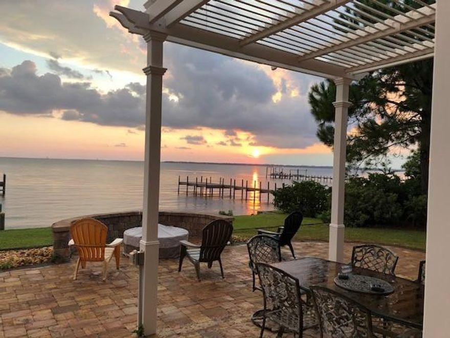 INCREDIBLE VIEWS FROM THIS WATERFRONT PROPERTY!!! IMMACULATE 2007 home is constructed with Insulated Concrete Forms (ICF), 12''+ thick exterior walls, brick exterior, Hip roof, & impact windows(back/sides). As you enter the 2-story foyer, the gorgeous BLUE bay water shimmers breathtakingly through the 2-story family room wall of windows. Open concept kitchen, large breakfast area, Dining room, & Bed#5/study flank the family room. 1ST floor bedroom SUITE is so spacious it could be used as a second master & the view is spectacular. Just above that bedroom is an identical bedroom SUITE on the 2nd floor. Main master suite is also on floor 2 & includes a large bedroom, walk-in shower, walk-in closet, & double vanities. Another standard size bedroom is also on floor 2. INC Dock/lift