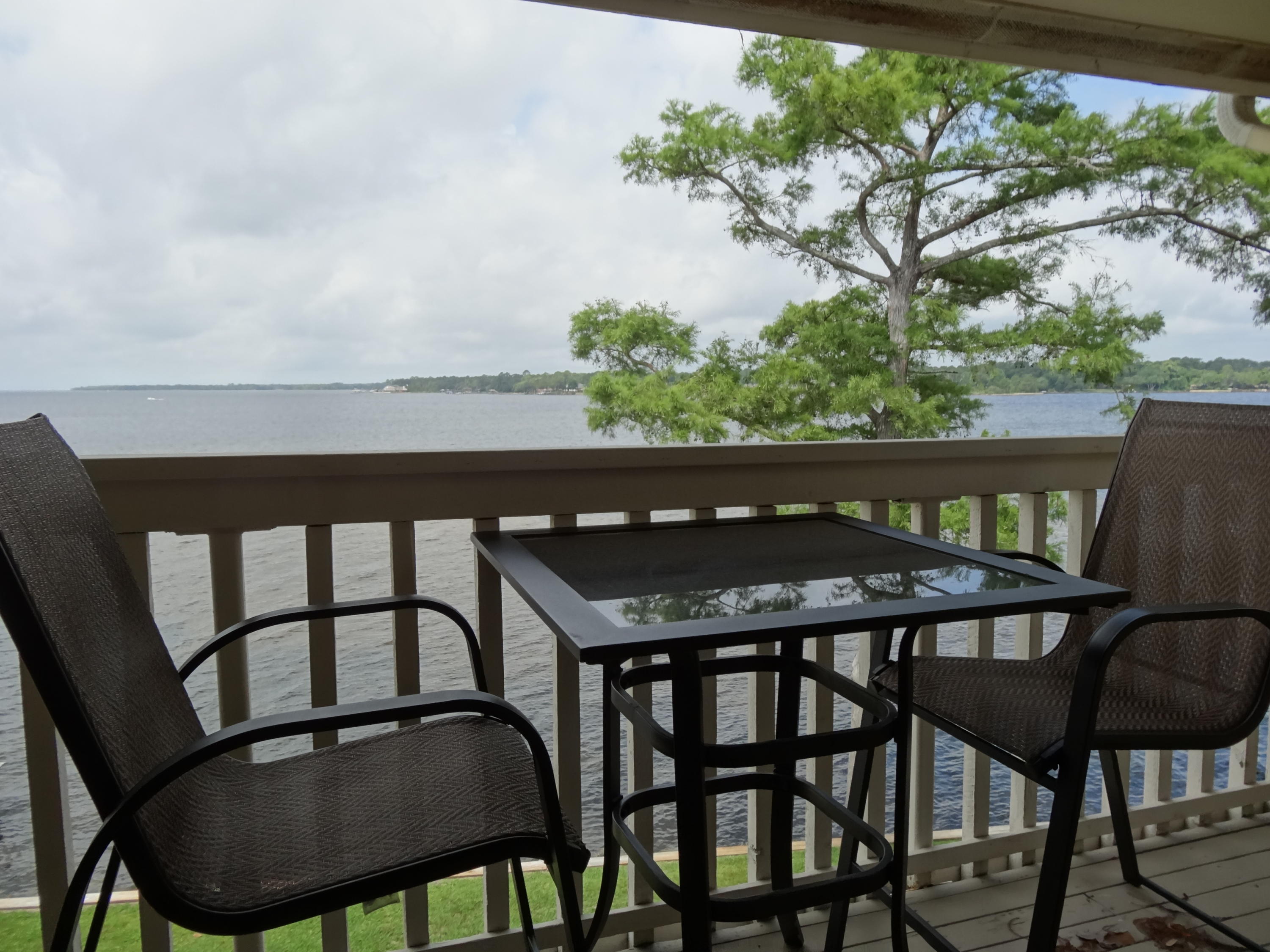 Situated on the bay and nestled among moss-draped oaks is a fully furnished, tastefully decorated condo to use as a primary home, weekend getaway or rental investment. Stunning Southwest sunsets and bay breezes are captured from the end unit balcony. The unit has been upgraded with new kitchen counters, cabinets and appliances. Amply equipped with small appliances, utensils and dishes ~ nothing to buy here! This unit also has full sized washer and dryer. The association tends to all exterior maintenance, water/sewer, pest control and hazard insurance.Within walking distance is a full service marina, restaurant and oyster bar where you can enjoy good food, fun and watch dolphins play. In addition to the marina, Bluewater Bay also offers golf, tennis and is a short drive to the beach!