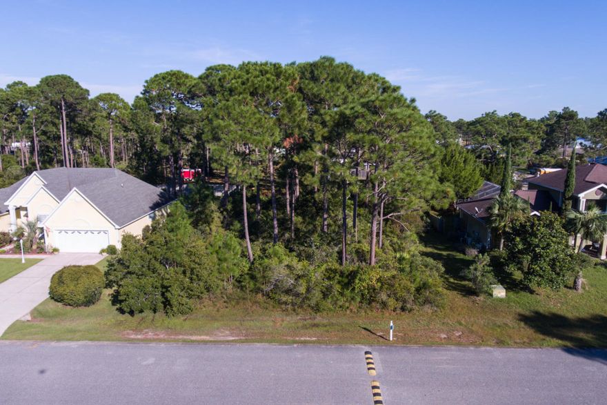 Exceptional & quiet gated community in highly sought after Pelican Bay in Santa Rosa Beach. This lot is located directly across the street from the tennis courts and features ample space to build your dream home. A water-front subdivision that is the ideal place to take a walk down to the private dock or enjoy the private bay-front park with picnic area for watching the sunset. LOW HOA and lots or owner pride throughout the community.