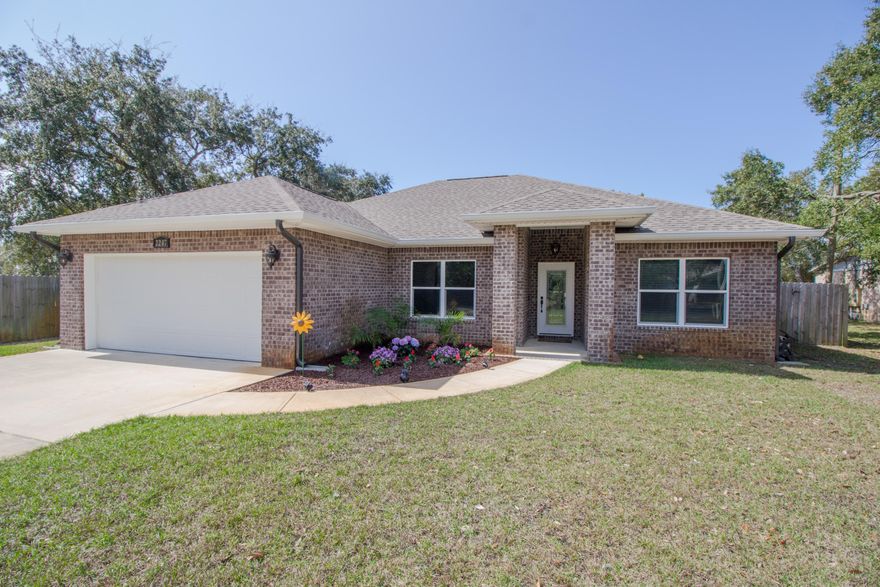 Welcome home to this completely custom, all brick 4 bedroom, no HOA Navarre home. You'll be greeted by a large, manicured front lawn and brand new floral landscaping & sod. Enter into an inviting, open concept great room with 10ft textured ceilings, accented with crown molding, and beautiful 48'' rustic wood tiling throughout the home. Finished bullnose corners, archway transitions, beautiful warm granite counters combine with custom extended length cherry cabinetry make the presence of the home stunning. The breathtaking master suite boasts tray ceiling, a walk-in bathroom w/ matching granite, dual vanity, and upgraded high end wood closet organizer. Step into beautiful custom glass tile walk in shower. Formal dining area overlooks stunning fenced, newly sodded backyard. The home comes with a dedicated laundry room, leading into the very spacious 2 car garage. A covered patio has room for outdoor living space furniture, a fire pit and grill. The large yard is perfect for relaxing, or allowing pets to roam freely as it is fully fenced. Enjoy your irrigation system running off of a well to not impact utility costs. Upgrades done to the home include debris shielded gutters, master closet organizer, professional interior painting of whole home, high end blinds in every room, entire home converted to LED lighting, custom kitchen backsplash, garage wall organizer for storage, NEST thermostat with RING video doorbell, and lastly a custom wall mount for flatscreen TV. You will not find a more renovated, more optioned home on the market today. To schedule an appointment for private showing, contact listing agent.