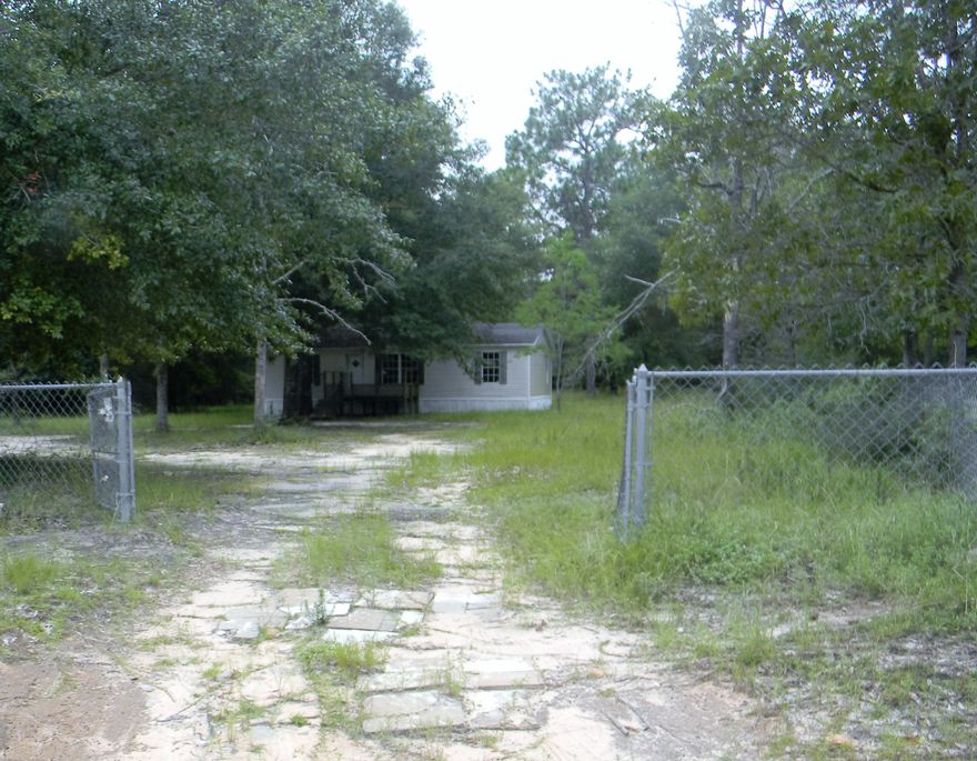 Country living can be enjoyed on this .92 acre of land. Wouldn't this be the perfect spot for your mobile home, manufactured home or new build as utilities, septic and water already exist. Property has an uninhabitable mobile home which conveys with no value, as is. The lot has been partially cleared but has some beautiful natural woods remaining in the backyard. A chain linked fence surrounds the perimeter of the property.