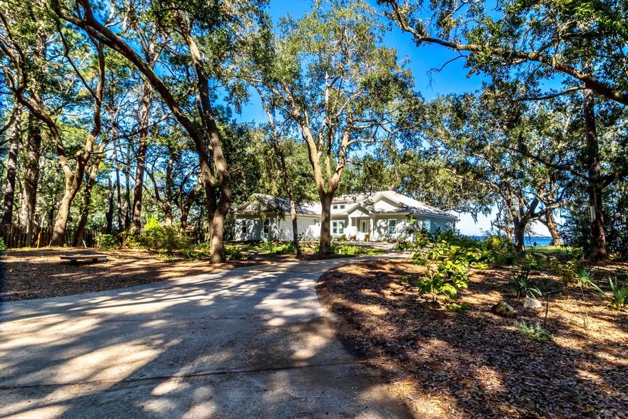 Bay lifestyle living at its best with no HOA. This charming bayfront home with dock is situated on over an acre of massive live oaks, graceful magnolias and towering pines along the sandy beaches of Choctawhatchee Bay. A wall of windows and French doors open onto a screened porch to offer expansive bay and forest views. Open concept floor plan. The kitchen features a gas range, farmhouse sink, granite countertops, custom cabinetry & black S/S appliances. Wood-look porcelain tile in every room. Rennai tankless water heater. Trey ceilings throughout. Walk-in closet and dressing area in Master BR. Oversize garage with pull down staircase and 18 foot garage door. 3 yard buildings for landscape equipment and beach toys. Enjoy kayaking, boating, fishing, or bayside dolphin watching.