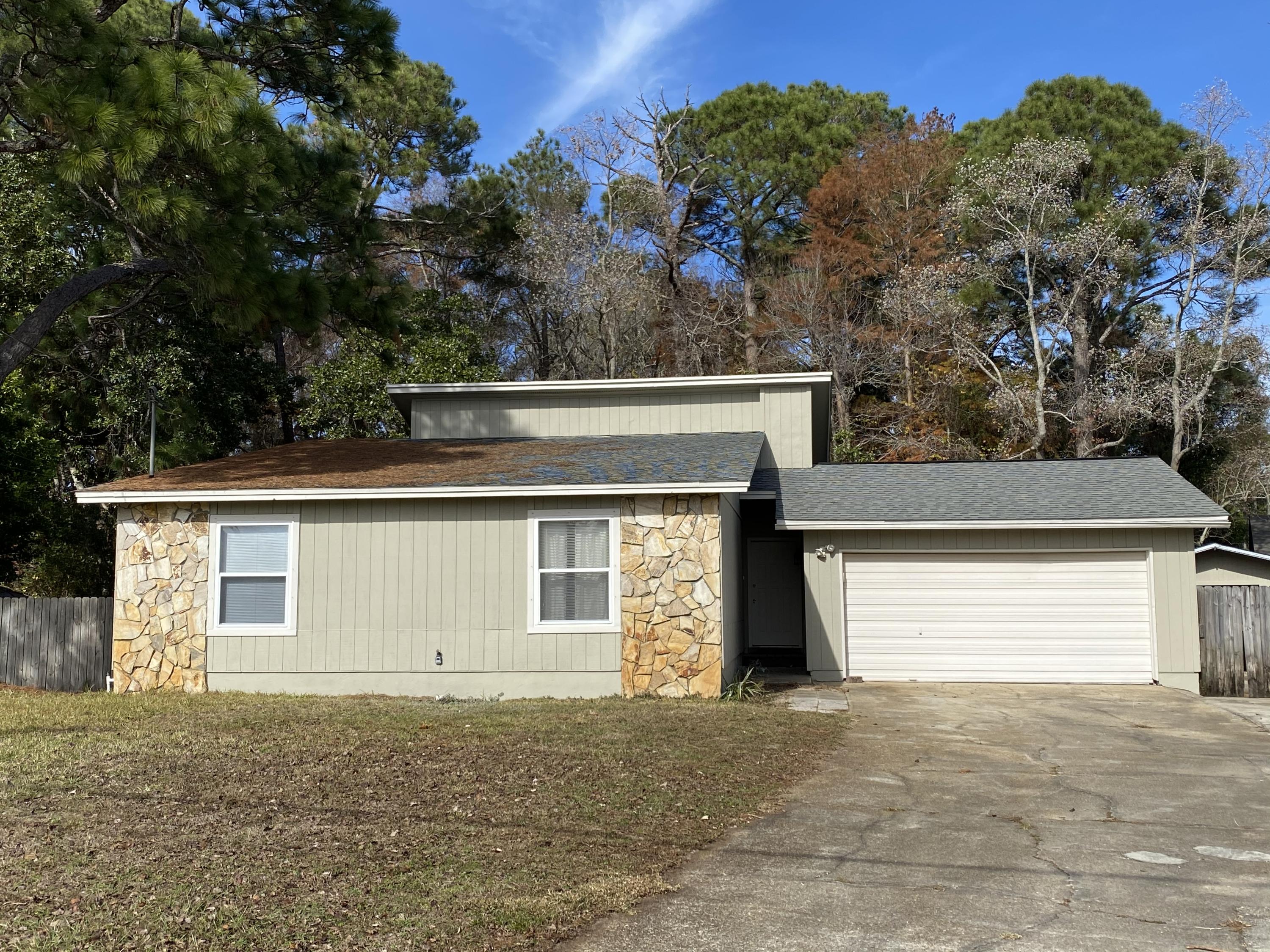 Fresh beautiful double garage home! Backs onto green space and Hurlburt field! This home features updated newer roof, newer A/C system, new luxury vinyl plank flooring! New paint in living room kitchen and dining! Large fenced yard with storage shed! Great location! VaCANT and ready for you to move in and enjoy! Extra high ceilings and beautiful warm fireplace in living room with double French doors to huge deck for entertaining or relaxing! Gate swings open for extra toy (Boat, RV, etc..) parking and accessing the back yard!