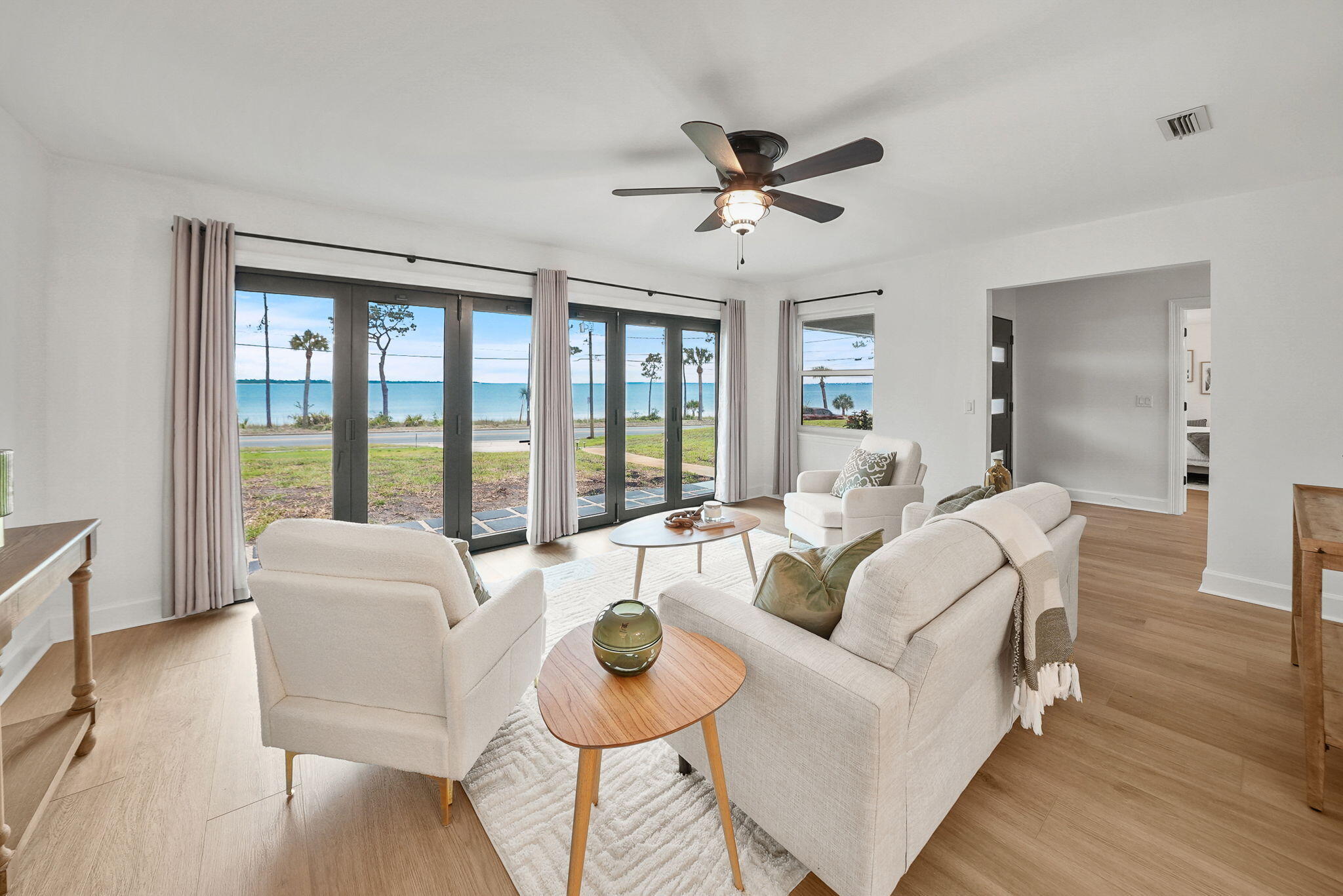 PRICE IMPROVEMENT + You Pick TWO! Choose TWO of the following with acceptable offer on this stunning WATERFRONT home:- 6 Seater Golf Cart- $15,000 in Closing Costs/Rate Buy Down- Hot TubThis waterfront home is positioned perfectly on picturesque Scenic Beach Drive, offering a unique blend of modern luxury and serene coastal living. This exquisite, recently renovated, one-story ranch-style home on .48 acres, encompasses 2,621 square feet, presents an exceptional opportunity for those seeking a slice of Florida's coveted waterfront lifestyle. This waterfront property is truly impressive-built for entertaining, complete with a back yard fire pit and ample room for a pool. Open the full glass bi-fold doors the entire length of the sitting room & enjoy sunsets year-round. And speaking of view - wait until the July 4th fireworks displays from the comfort of your own home, a hallmark of scenic Beach Drive known for its pure bay views.
The home's interior has been fully renovated as it was taken down to the studs replacing electrical, plumbing, HVAC, windows, water heater, sheetrock and more. The design truly reflects a modern, bright aesthetic and one of the best features is that it's on a single level with no stairs. The open floor plan is accentuated by abundant windows, allowing natural light to flood the space and offering picturesque views of the bay. The kitchen is a chef's dream, equipped with a large island, upgraded appliances and elegant quartz countertops. Full glass bi-fold doors in the sitting area seamlessly blends indoor and outdoor living, opening up to reveal the tranquil waterfront setting. One of the best features in this home is the open concept which provides two living areas, one adjacent to the kitchen and one overlooking beautiful St. Andrews Bay.
Boasting three spacious bedrooms and three and a half bathrooms, each bedroom is thoughtfully designed with its own en suite bath, ensuring privacy and comfort for all residents and guests. A powder room is convenient adjacent to the foyer, as well. The expansive primary suite in this single level home is a true retreat, featuring breathtaking views of St. Andrews Bay, a zero-entry, roll-in tiled shower, dual vanities and a large walk-in custom closet.
The property includes a two-car garage and deeded access to the waterfront, enhancing its appeal as prime waterfront. Its central location between the booming Downtown Panama City area and the vibrant Historic St. Andrews. Residents can enjoy walking to local farmers markets, breweries, boutique shops, and different dining options. The area is also bike-friendly and known for its community events, parades, pubs, restaurants, and marinas. The waterfront lifestyle doesn't end at home which is even more incredible! Walk or bike down Scenic Beach Drive to an array of activities allowing you to live your best waterfront life!
This property not only provides a luxurious living experience but also holds incredible rental potential with no HOA, allowing you and your guests to immerse themselves in the quintessential Florida waterfront lifestyle. You'll enjoy accessing the Bay by kayaks, paddleboards or just relaxing in the water for a swim.