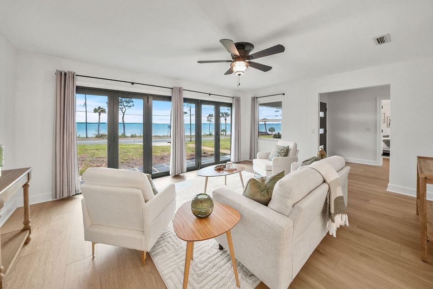 NEW Price Improvement to $1,158,888 on this stunning WATERFRONT home that offers two parcels - an exceptional opportunity to own the waterfront land on the BAY!Bring an offer on this waterfront home is positioned perfectly on picturesque Scenic Beach Drive, offering a unique blend of modern luxury and serene coastal living. This exquisite, recently renovated, one-story ranch-style home on .48 acres, encompasses 2,621 square feet, presents an exceptional opportunity for those seeking a slice of Florida's coveted waterfront lifestyle. This waterfront property is truly impressive-built for entertaining, complete with a back yard fire pit and ample room for a pool. Open the full glass bi-fold doors the entire length of the sitting room & enjoy sunsets year-round. And speaking of view - wait until the July 4th fireworks displays from the comfort of your own home, a hallmark of scenic Beach Drive known for its pure bay views. 

The home's interior has been fully renovated as it was taken down to the studs replacing electrical, plumbing, HVAC, windows, water heater, sheetrock and more. The design truly reflects a modern, bright aesthetic and one of the best features is that it's on a single level with no stairs. The open floor plan is accentuated by abundant windows, allowing natural light to flood the space and offering picturesque views of the bay. The kitchen is a chef's dream, equipped with a large island, upgraded appliances and elegant quartz countertops. Full glass bi-fold doors in the sitting area seamlessly blends indoor and outdoor living, opening up to reveal the tranquil waterfront setting. One of the best features in this home is the open concept which provides two living areas, one adjacent to the kitchen and one overlooking beautiful St. Andrews Bay. 

Boasting three spacious bedrooms and three and a half bathrooms, each bedroom is thoughtfully designed with its own en suite bath, ensuring privacy and comfort for all residents and guests. A powder room is convenient adjacent to the foyer, as well. The expansive primary suite in this single level home is a true retreat, featuring breathtaking views of St. Andrews Bay, a zero-entry, roll-in tiled shower, dual vanities and a large walk-in custom closet. 

The property includes a two-car garage and deeded access to the waterfront, enhancing its appeal as prime waterfront. Its central location between the booming Downtown Panama City area and the vibrant Historic St. Andrews. Residents can enjoy walking to local farmers markets, breweries, boutique shops, and different dining options. The area is also bike-friendly and known for its community events, parades, pubs, restaurants, and marinas. The waterfront lifestyle doesn't end at home which is even more incredible! Walk or bike down Scenic Beach Drive to an array of activities allowing you to live your best waterfront life! 

This property not only provides a luxurious living experience but also holds incredible rental potential with no HOA, allowing you and your guests to immerse themselves in the quintessential Florida waterfront lifestyle. You'll enjoy accessing the Bay by kayaks, paddleboards or just relaxing in the water for a swim. 