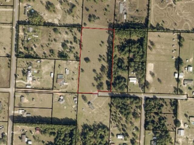 Escape to nearly 5 acres of peaceful country living on this beautiful 4.93-acre parcel, zoned Rural Residential Agriculture (AG-RR), perfect for those seeking a quiet lifestyle with room to grow. Located at the end of a cul-de-sac on a paved road, this high and dry lot is level, partially fenced, and offers a mix of open pasture and shaded trees, ideal for horses, farming, or building your dream home. With a density allowance of 1 dwelling per acre, there's also potential for low-density residential use. AG-RR zoning supports single-family homes and allows for accessory structures and certain community-oriented uses that complement the rural setting. Mobile homes are allowed, and the area features a blend of newer homes and open land. Enjoy country living just minutes from shopping in Mil ton and Pace, with quick access to I-10, making Pensacola and Navarre Beach easily accessible.