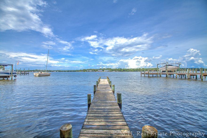 Everyone wants to live on the water, especially in Niceville! This homes interior has been extensively remodeled with a fabulous new kitchen with all new appliances to include a gas stove and quartz counter tops! There are 3 high end renovated bathrooms, new herringbone tile flooring throughout the two living rooms, dining room and kitchen. The 4 bedrooms have new carpet and the entire home has been freshly painted. The HVAC is 2008, The roof is 2004, double pane tilting windows were installed in 2002. Outdoors you will enjoy stunning sunsets and a remarkable water view! There is an enclosed 32x16 in-ground pool which is great for swimming laps or for summer shin digs and shenanigans as it's 10' deep on one end & 3' in the shallow end. * Buyer to verify square footage * Sold AS IS.