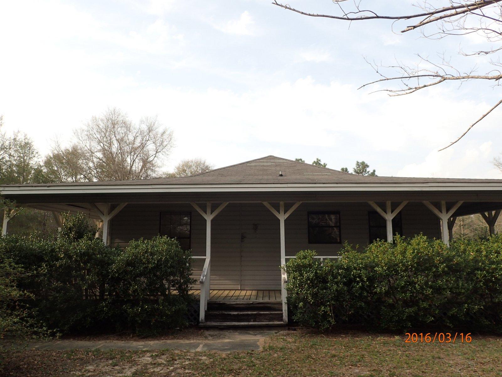 This REO home is the one! This large home is located mins from Crestview's High School, middle schools, Bob Sikes Airport, grocery shopping and more. A short drive to south Crestview as well making it extremely convenient on many fronts! Resting on 2 acres, this unique home was built 1986 and comes with 3 bedrooms and 2 baths. A large wrap around porch adorns the exterior and home has a large detached 2 car garage and additional paved parking. Open great room with fireplace as well as a large kitchen and dining area. Home needs some repairs and therefore will not qualify for all types of financing, but definitely worth the consideration. This one will not last so call asap!