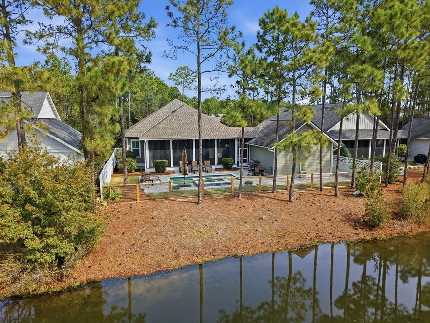 This gorgeous, single-level home offers a highly livable floor plan and is ideally located in WaterSound Origins, just minutes from Highway 98. The peaceful backyard overlooks a serene pond and protected natural area that will remain undeveloped, providing lasting privacy and beautiful views.  The home features exceptional indoor-outdoor living, including a screened porch with fireplace that opens to a heated saltwater pool and hot tub--perfect for relaxing or entertaining year-round. With four bedrooms and a thoughtfully designed layout, the home is well suited for a full-time family residence or for hosting visiting friends and family. Situated on a street with community walking trails that wind through native plants and foliage, the setting creates a true connection to nature. MO The home features exceptional indoor-outdoor living, including a screened porch with fireplace that opens to a heated saltwater pool and hot tub--perfect for relaxing or entertaining year-round. With four bedrooms and a thoughtfully designed layout, the home is well suited for a full-time family residence or for hosting visiting family and friends.The home has numerous builder upgrades designed to enhance both comfort and functionality. 10-foot ceilings create an open, airy feel, complemented by custom wainscoting, crown molding, and detailed trim work throughout the main living spaces. Built-in bookshelves anchor the den and living area, while a hallway bar features a wine cooler with custom cabinetry--ideal for entertaining.

Indoor living flows seamlessly outdoors to a private backyard retreat featuring a pool and spa, outdoor fireplace, and upgraded paver walkway extending from the driveway to the pool. The garage is fully air-conditioned, adding versatility and year-round usability.

Additional original builder enhancements include custom cabinetry and a laundry room closet, ceiling fans in all bedrooms, the den, and porch, wiring for a sound system in the den and back porch, and custom shutters throughout the home and garage. In the primary bath, battery-operated shutters allow for effortless light and privacy control.

The home has been meticulously maintained, with recent updates including a full exterior repaint in July 2024, refreshed white fencing along both sides of the pool, replacement of the rear pool fence, a new dishwasher installed in September 2025, and a new HVAC system completed in December 2025.