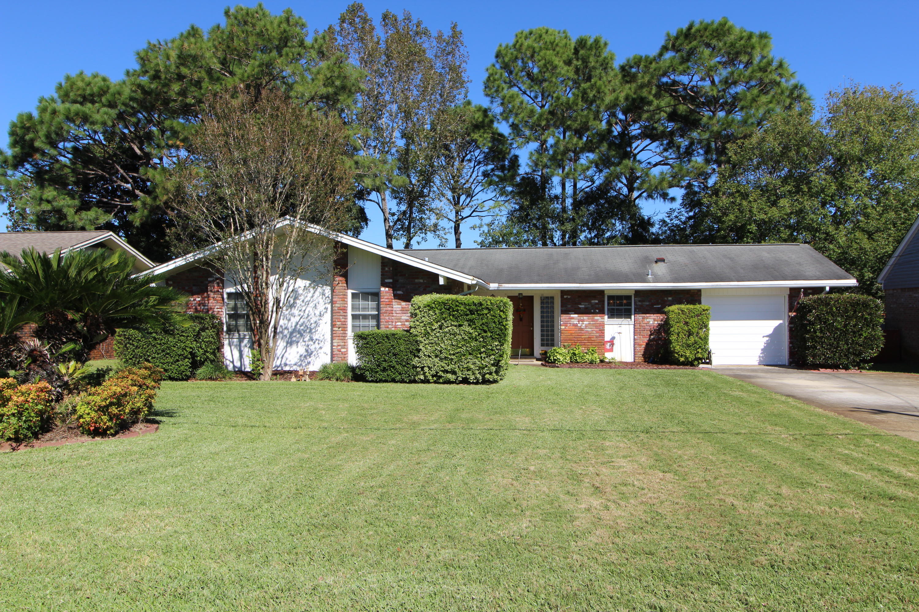 Home Sweet Home! Pride of ownership shows throughout this well-maintained home. Warm and inviting living room with crown molding, corner brick fireplace and sliding glass doors that lead out to your 27ft x 11ft screened-in Florida room. Family room offers you additional living space with an extended cabinet that can also be removed if desired. Spacious and open kitchen with quartz counter tops, tiled backsplash, lots of cabinets, designer lighting, upgraded stainless appliances pantry and breakfast bar. Dining area has chair railing and sliding glass door that leads to the screened-in room. Inside laundry/utility room for extra storage. Master bedroom has a walk-in closet. Master bath newly updated with extended vanity, tile flooring and a walk-in custom tiled shower.