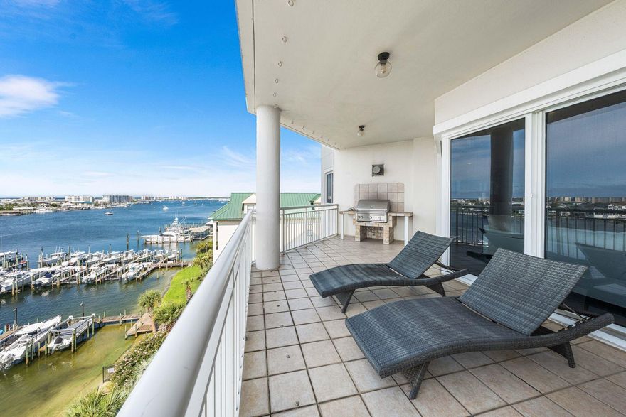 Assumable VA loan at 2.75 percent. Positioned on the prime west end of Grand Harbor's fifth floor, this four bedroom four bath residence delivers uninterrupted views of both the Gulf of America and Destin Harbor from nearly every main living space. Wide sightlines and generously sized rooms keep the water in focus, with Gulf and Harbor views flowing through the primary suite, guest bedroom, kitchen, living room, and dining area, which can easily flex into an additional living space. An oversized balcony overlooks the harbor with the Gulf beyond and includes a built in gas grill for sunset dinners. Inside, the living area connects seamlessly to a remodeled kitchen with quality finishes, 9.5 foot ceilings, plantation shutters, and a full wet bar. Every bedroom includes a private bath. Behind the gates, Grand Harbor offers a rare sense of quiet exclusivity. Owners enjoy a secure parking garage, private marina access, fitness center, clubhouse, heated waterfront pool, and a reserved guest suite for visiting friends or family. With no short term rentals permitted, the community remains private, calm, and truly residential while still delivering front row Gulf and Harbor views.