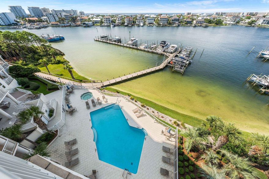 Assumable VA loan at 2.75 percent. Positioned on the prime west end of Grand Harbor's fifth floor, this four bedroom four bath residence delivers uninterrupted views of both the Gulf of America and Destin Harbor from nearly every main living space. Wide sightlines and generously sized rooms keep the water in focus, with Gulf and Harbor views flowing through the primary suite, guest bedroom, kitchen, living room, and dining area, which can easily flex into an additional living space. An oversized balcony overlooks the harbor with the Gulf beyond and includes a built in gas grill for sunset dinners. Inside, the living area connects seamlessly to a remodeled kitchen with quality finishes, 9.5 foot ceilings, plantation shutters, and a full wet bar. Every bedroom includes a private bath. Behind the gates, Grand Harbor offers a rare sense of quiet exclusivity. Owners enjoy a secure parking garage, private marina access, fitness center, clubhouse, heated waterfront pool, and a reserved guest suite for visiting friends or family. With no short term rentals permitted, the community remains private, calm, and truly residential while still delivering front row Gulf and Harbor views.