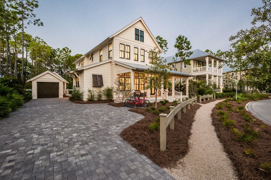 Reminiscent of a two-story country farmhouse with an inviting, wide, wood plank front porch, this charming WaterColor home offers more than 3,700 square feet of luxury living, five bedrooms and four and a half bathrooms. The property features abundant outdoor relaxation and entertainment areas. Family and guests can enjoy a screened porch on the side or mingle behind the house around a heated pool, fire pit, and dining and lounging space on paver surfaces. A grill station, wet bar, TV, food prep area and Sonos outdoor speaker system raise the bar on fabulous outdoor living amenities.The interior is a sophisticated blend of open contemporary and Nantucket ambience with a splash of rustic in reclaimed wood beams.