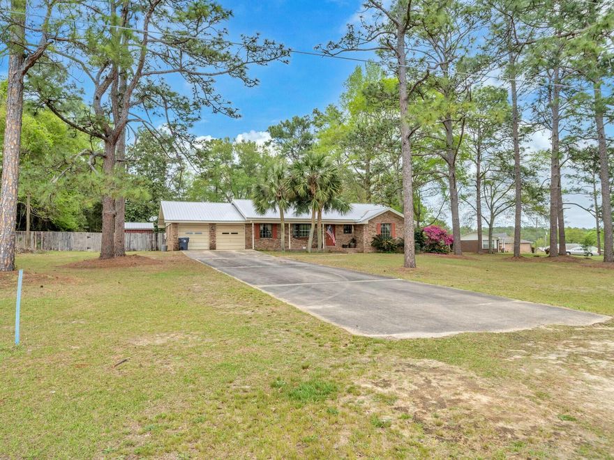 Welcomed by a classic brick walkway, this charming home features an expansive 4'x35' front porch designed for relaxation with a view of the lake. Upon entering, you're greeted by an open-concept living space that seamlessly connects the living room, den, and dining room, all adorned with elegant bamboo flooring. The den's cozy wood-burning fireplace creates a warm focal point, while the recently renovated bathrooms showcase modern tilework, updated fixtures, and water-efficient toilets.The fully climate-controlled four-season porch offers year-round comfort with dedicated heating and cooling, ideal for enjoying natural light regardless of the season. Practical upgrades include a freshly painted interior, a spacious utility room with soaking sink and laundry hookups, and a two-car garage equipped with dual electric openers. The kitchen and bathrooms feature durable tile flooring, contrasting with the home's natural bamboo aesthetic.
Set on 1.049 acres, the property includes a large utility building (requiring repairs), a new workshop, and above ground pool. This move-in-ready home blends modern amenities with timeless appeal, offering a perfect balance of functionality and comfort.
