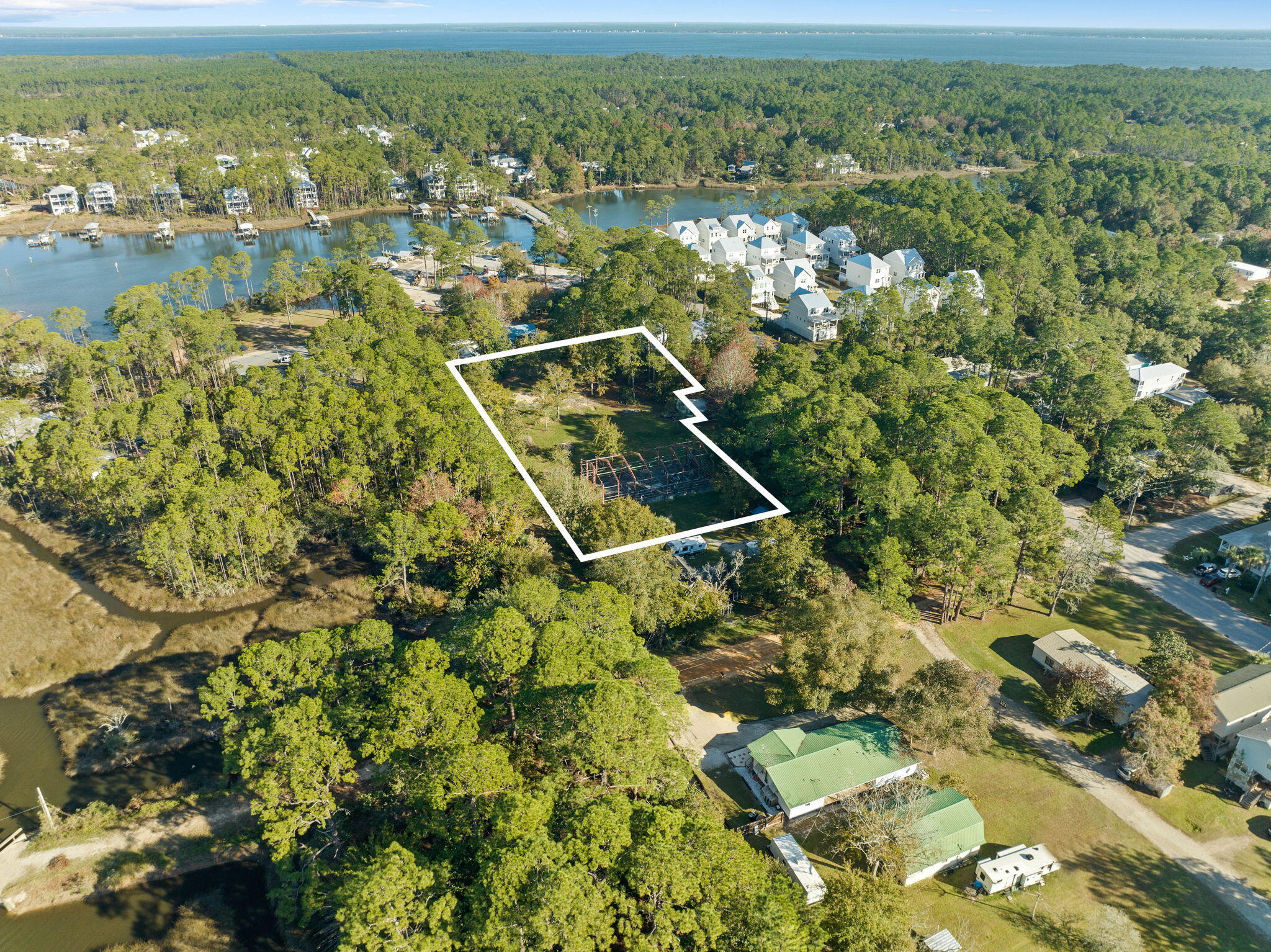 Nestled in the heart of Santa Rosa Beach, this exceptional property features multiple buildable lots, offering prime opportunities for residential development. Free from HOA restrictions, these lots provide a blank slate for creating custom homes that align with modern lifestyles. This rare assembly of lots, with no wetlands, provides the ideal canvas for a visionary development, offering endless possibilities for residential or investment projects in the heart of Santa Rosa Beach. With the area experiencing steady growth and attracting new residents drawn to its natural beauty and convenient location, the appeal of owning and investing in this sought-after area continues to rise. The property does feature a pre-existing concrete foundation and steel framework for a residential home however it was never completed. Permit (# 08-1219) is open and was renewed in 2024. To build multiple lots, buyer would need to subdivide the parcel. Property being sold AS IS. Information contained within this listing such as lot dimensions, is deemed to be accurate but is not guaranteed. Buyer to verify. Additional Parcels available to purchase MLS #: 970731 & 970729.