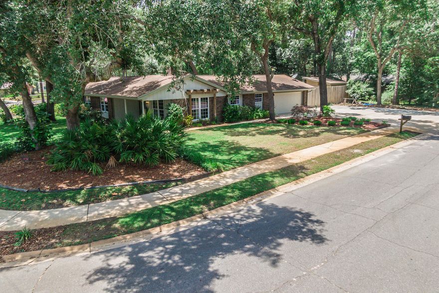 Welcome home! Beautifully RENOVATED 3 bedroom, 2 bath, located in the heart of Niceville!The sunny kitchen offers new GRANITE countertops, stainless-steel appliances, and refaced cabinetry. NEW WOOD LOOK TILE FLOORING throughout the main areas of the home, and newer carpet in each bedroom. Gorgeous formal living room, and a second living space with a beautiful fireplace and custom mantel. Master bedroom suite has a  GORGEOUS modern bathroom & large master closet! Back yard is an OASIS perfect for entertaining on the large deck giving you a serene and private space. In addition to the 2-car garage, driveway has been expanded - enough space for 6 cars, an RV and/or a boat! Back yard has an oversized storage shed.NEW HVAC, Windows (2018), Roof 2009, and Gas water heater (2012).Easy access