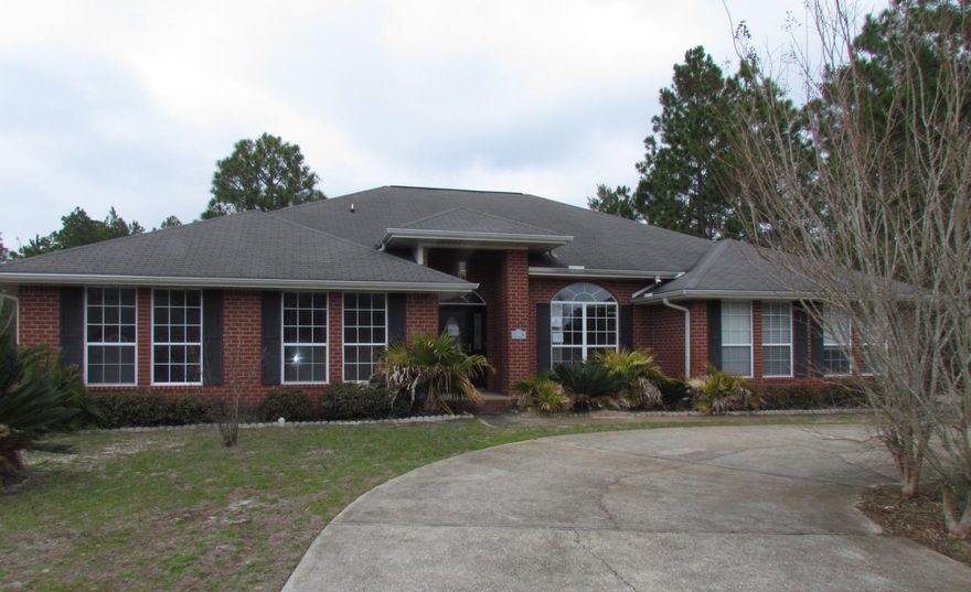 REO Opportunity knocks in Holley by the Sea with this 4 bedroom, 3 bath house that sits on .76 of an acre! The circular drive at this house takes you to the side entry garage and extra parking space for your boat or RV!! When you enter the house with cathedral ceiling, the dining room will be to your right with a large window overlooking the front yard. The living room straight ahead with a fireplace and planter shelves offers a lot of elbow room. The door to the back of the living room takes you out the extra large bonus room that was added. The kitchen is off to the right and is extra large! Ample amount of cabinets and counter space. There is also an island in the kitchen with a window looking out to the side yard. There is a walk in pantry room off the kitchen and on the other sid