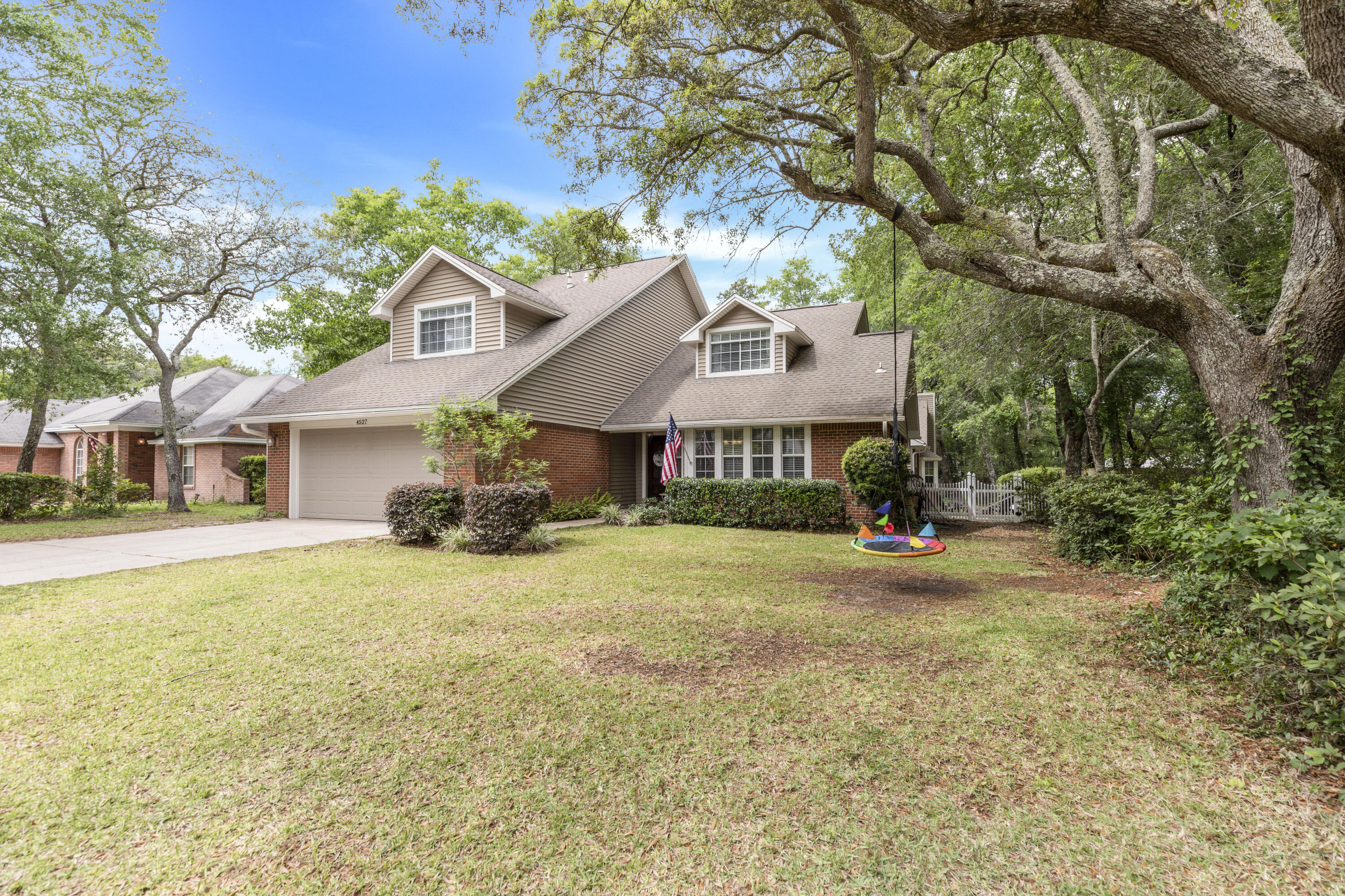Stunning 5 Bedroom, 3.5 Bath home located in the Highly Desired and Gated Neighborhood of Parkwood Estates, and it's just a short walk to Bluewater Elementary! Located on a large lot with mature trees. 1st Floor Master Suite has his and her closets, dual sink master bath, separate shower and jetted tub. Large bonus suite with a large bedroom, with full bath, family room and kitchenette that can serve as a Mother-In-Law Suite, home-schooling area, or entertainment space. Beautiful ceramic wood plank tiles throughout first floor of main home, Insulated Siding (2017), Newer A/C system for bonus suite, and various other upgrades. Complemented with two fireplaces, breakfast nook, formal dining, and screened lanai great for entertaining. Seller will be putting on a new roof prior to closing.