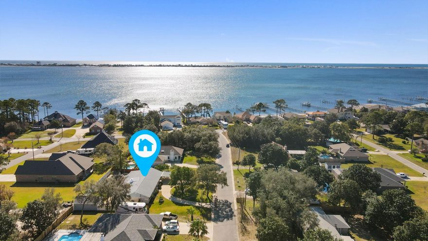 Craftsmanship abounds in this stunning 4 BR 3B home. A beautiful brick fireplace, luxury vinyl plank and marble tile floors, new carpet, wainscotting and exposed brick walls are featured. The kitchen and laundry room boast modern appliances, and a stand alone tub sits by a double vanity in the spa-like master bath. The spacious fenced in yard is large enough to park your boat and contains a detached garage that could easily double as a workshop.  Did we mention that this home has deeded water access! Everything here says ''Welcome Home.''Buyer is responsible for verifying all data and information including lot size and room measurements as it is deemed to be reliable but not guaranteed