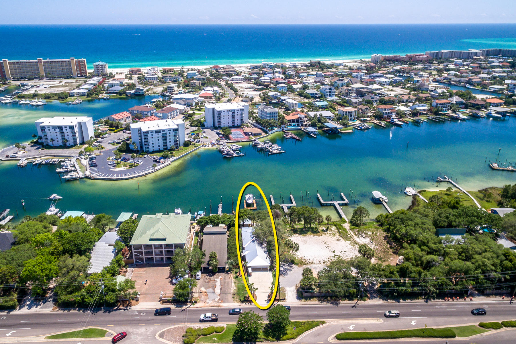 SIGNIFICANT PRICE REDUCTION! (3) DEEP-WATER BOAT SLIPS on the Harbor!Quintessential harbor-front cottage on the scenic harbor in Destin, Florida! This property offers sensational mooring capability for multiple watercraft on its expansive dock, which features new decking, a robust boat lift and a tackle shed. Its private beach is perfect for sunbathing, or perhaps launching paddleboards and kayaks. Evenings will be a delight on the backyard porch, perched notably atop a bluff, providing beautiful vistas across the Harbor to the East Pass and Gulf of Mexico. The cottage offers a floorplan that would cater effectively to a lock-out configuration for independently accommodating guests. Many aspects have undergone improvement including a new roof, landscaping, and driveway.