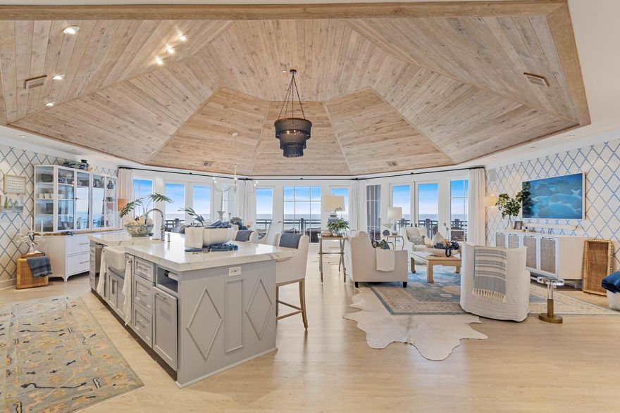 This luxury penthouse dares to challenge convention with a semi-octagonal floor plan that maximizes gulf-front views within the exclusive WaterSound development. Soaring 20-foot ceilings, oversized windows and an interesting open floor plan create a fabulous beach home that can never be termed 'dull and boring.' Coastal architecture includes the best of Southern living with deep porches and wide overhangs creating shady seating areas with unobstructed dune and gulf views. Turn-key, fully furnished and designed by Graham Gund Architects of Boston, this stunning beach home boasts wide-plank flooring and fabulous decor and furnishings by VLG Interiors.