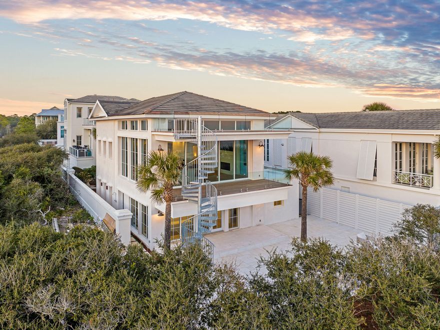 Welcome to 40 Jasmine Circle, a completely renovated Gulf-front oasis finished in the luxurious style of Alys Beach and ideally located in the heart of 30A, just steps away from Seaside. Perched 30 feet above the water and constructed with poured concrete, steel framing, and brand-new Cat-5-Rated windows, this home is built to withstand the elements Gulf front living.The exterior of the home has been finished meticulously, with elegant Alys-Beach-style smooth stucco, a large Gulf front patio, and a new third story viewing deck to take in unparalleled views of the Emerald Coast. The interior of home is truly special. From the moment you walk in the front door, you are greeted by the unmistakable marks of elite craftsmanship and ultra-luxury finishes.