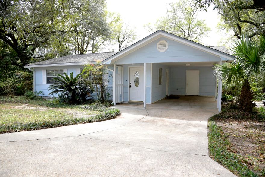 Bring your investors or buy this one yourself! Cute Florida cottage is nestled among mature landscaping on a fully fenced large corner lot. It's ready for you to add your own personal touches and updates. You'll find tile flooring throughout the main living areas and carpet in the 3 bedrooms. The kitchen has a gas cooktop, wall oven, refrigerator and a 2021 stainless dishwasher. The front loading washer and dryer remain and are located in the storage room/laundry area accessed from the carport. There is also a shed/workshop with electricity and workbench in the backyard. The septic tank was pumped in December 2023, HVAC is 2020, electric HWH 2007, roof 2003. The breaker box has also been replaced. This has been a great rental and neighborhood has no HOA!