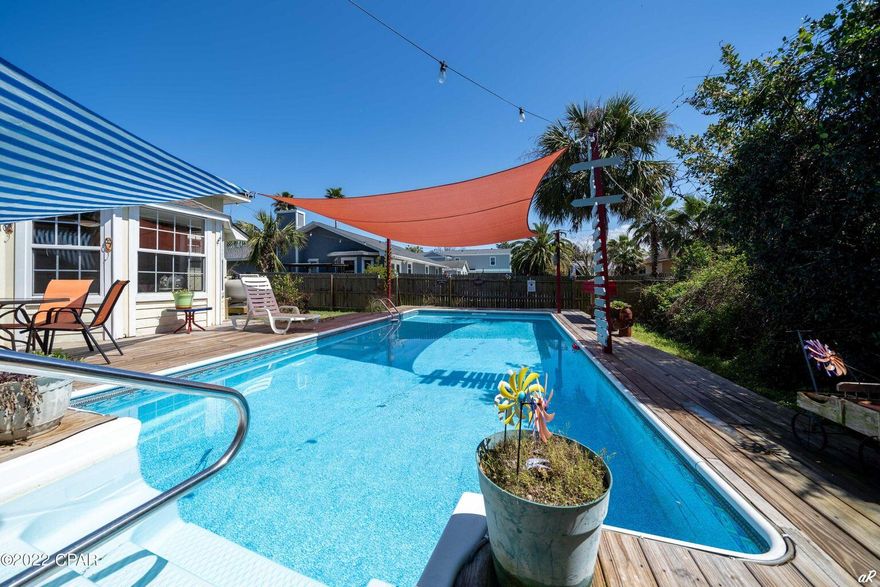 UNDER CONTRACT WITH CONTINGENCIES; SELLER ACCEPTING BACKUP OFFERS.Great location south side of 98 within an 1/8 mile to the beach or enjoy a little piece of paradise right at home with your own pool and tropical paradise. This home is a 3 bedroom, 2 bath with a double car garage. Plenty of room for additional parking to keep your golf cart handy for a short ride to the beautiful beaches of PCB. This home is perfect for a primary residence or 2nd home. So much personality throughout each room, furnished and designed for that beachy appeal you will sure to appreciate.