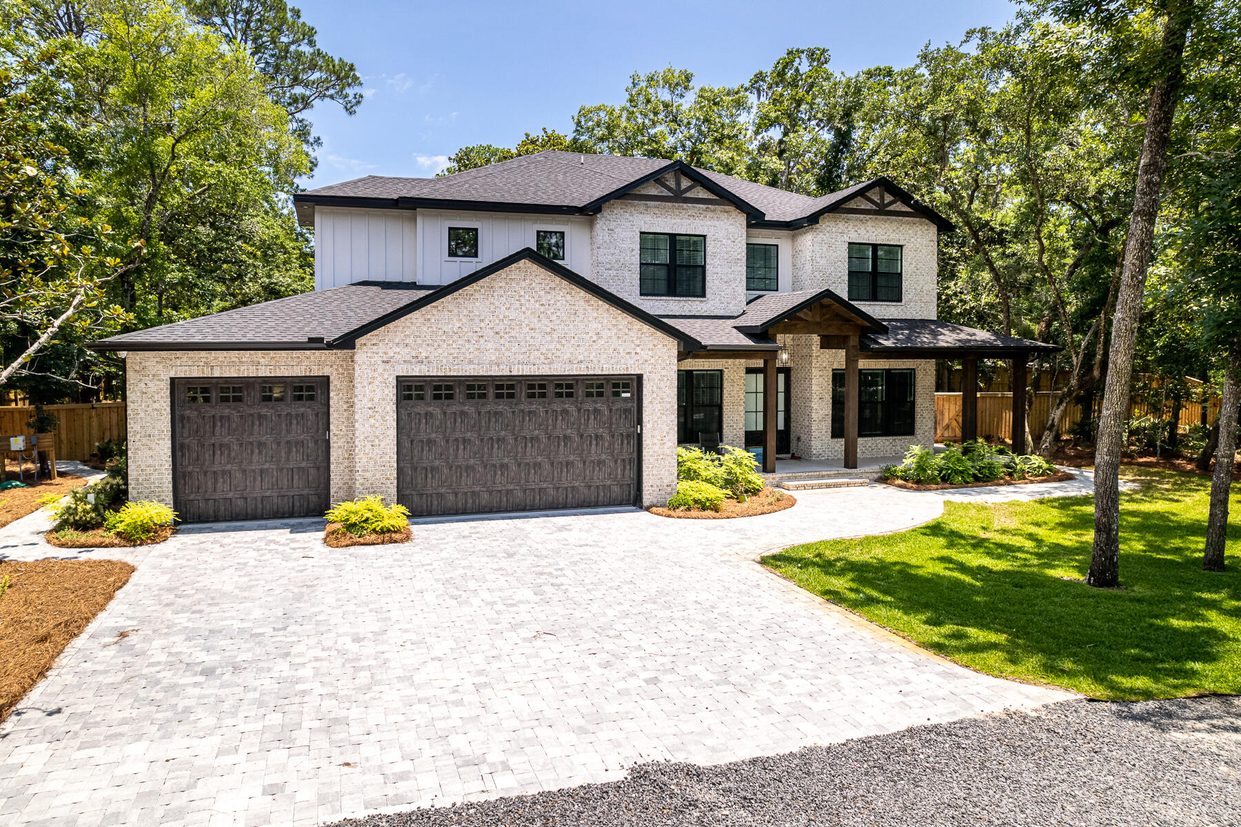 Welcome to the 'newly built' 80 Woodland Bayou Drive! Beauty and serenity are hallmarks of this superbly situated 3-acre, canal-front property with beautiful landscaping and unmatched privacy from the mature hard wood trees and panoramic driveway. Entertain friends and family on your 200-feet of waterfront property which includes a brand new dock (the perfect place to park the jet skis and a small boat!). The backyard oasis boasts a large, heated saltwater pool and steps away is a custom, high-end propane bonfire pit with seating. Rinse off after a day on the boat in the outdoor shower! Extensive yard lighting adds evening and nighttime ambiance to any gathering.