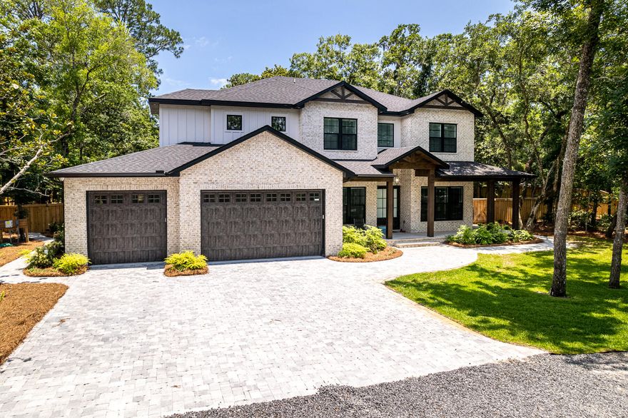 Welcome to the 'newly built' 80 Woodland Bayou Drive! Beauty and serenity are hallmarks of this superbly situated 3-acre, canal-front property with beautiful landscaping and unmatched privacy from the mature hard wood trees and panoramic driveway. Entertain friends and family on your 200-feet of waterfront property which includes a brand new dock (the perfect place to park the jet skis and a small boat!). The backyard oasis boasts a large, heated saltwater pool and steps away is a custom, high-end propane bonfire pit with seating. Rinse off after a day on the boat in the outdoor shower!  Extensive yard lighting adds evening and nighttime ambiance to any gathering.