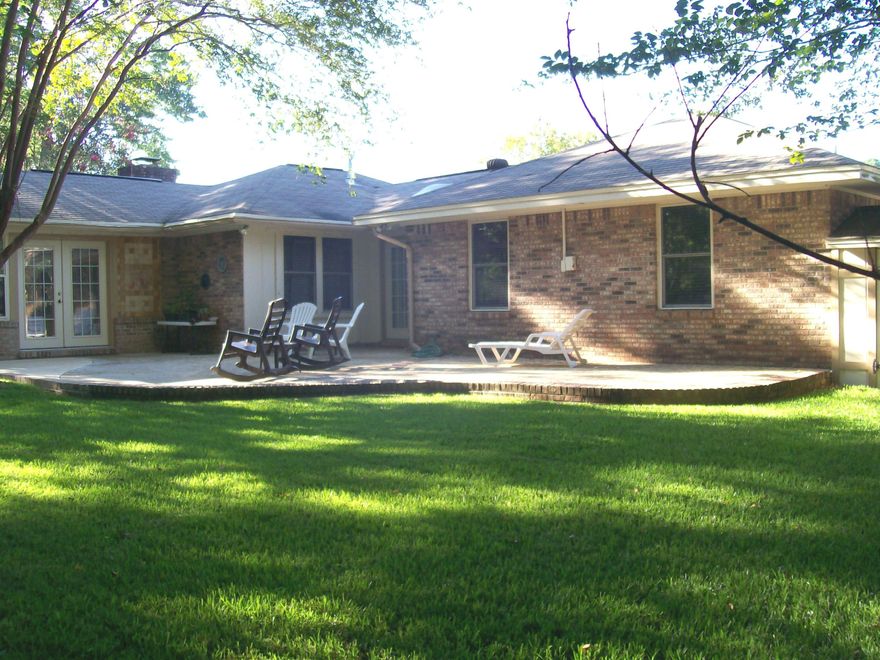 This home is on a large, spacious, corner lot w/attractive landscaping. Brick pavers lead to a fully tiled modern home w/vaulted ceiling & wood burning fireplace. The Master bath is updated & the Master Bedroom has plenty space for a queen/king bed. The walk-in closet is a nice bonus. Both bathrooms are fully tiled in the shower & the cabinetry matches throughout the house. Exquisite granite countertops and all wood cabinets are very attractive and stainless steel appliances make the kitchen inviting. Crown molding throughout the house gives it a showcase display. Side lights highlight the FP. A new gas water heater was installed in 2017, the air conditioner replaced, 2015. The back porch as been wired to hold a hot tub and the side porch is completely bricked, tiled, covered. A must see! The 2 car garage has built-in cabinets that are great for tool storage and the back yard has a storage room for lawn equipment.  Extra bonuses are the new gas water heater was installed in 2017, HVAC system in 2015, and a brand new wood fence.  Some windows have storm boards to protect them with easy hanging from the current attachments.  This lovely,      spacious home is a must see!