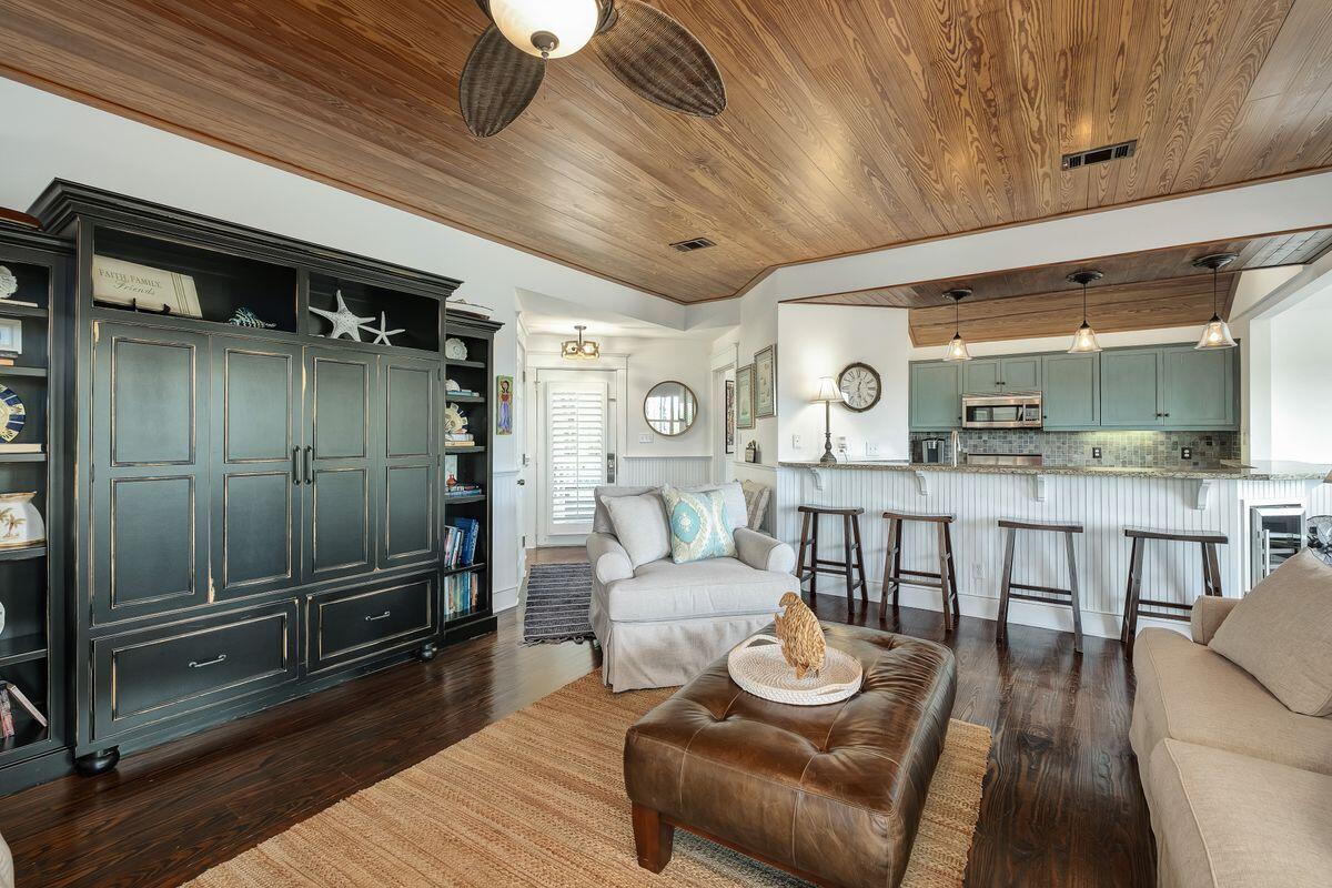 Just minutes from Sandestin amenities, this luxury cottage stands in its own unspoiled oasis. Backing onto undeveloped wilderness, it enjoys delightful views of the bay and canal through mature greenery. Pecky cypress ceilings bring the outdoors in, tying this unpretentious home to its stunning surroundings. The open living room is enhanced by seasoned heart-of-pine flooring echoing the timber ceiling and white wood wainscoting. A comfortably furnished sitting area with a custom entertainment center is destined for cozy evenings with family and friends. Open the doors into the expansive wrap-around porch that is the ideal space for relaxing and unwinding while enjoying the sights and sounds of nature. The formal dining space is sure to be the gathering place for family meals and
