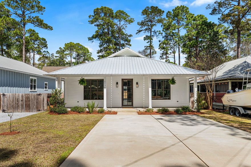Built in 2022 and located in the Magnolia Beach community, this charming Florida cottage at 1175 E Point Washington Road offers modern finishes and relaxed coastal style just north of Highway 98 in Santa Rosa Beach. The home features classic white Hardie board lap siding, a metal roof, and an inviting oversized front porch, along with a back porch and a beautifully landscaped, fully fenced backyard ideal for outdoor living. Inside, nearly 1,820 square feet of thoughtfully designed living space showcases hardwood floors throughout, an open-concept layout, and tasteful updates at every turn, creating a bright and welcoming atmosphere for both everyday living and entertaining. This single-story residence includes three bedrooms, two and a half baths, and a dedicated office located just off the main living areaperfect for remote work, a playroom, or flexible use. The kitchen serves as the heart of the home with an island, ample cabinetry, appliances, and a walk-in pantry, flowing seamlessly into the spacious living area. The primary suite features a walk-in closet and an en-suite bath with double vanities, a large walk-in shower, and linen storage. Two additional bedrooms share a full bath, while a laundry and coat closet sit conveniently across the hall. Additional highlights include off-street parking for two vehicles, an automatic sprinkler system, and low-maintenance landscaping.

Ideally positioned just blocks from the Choctawhatchee Bay and approximately half a mile from public bay access, this home offers easy access to boating, kayaking, paddleboarding, and fishing. The location is also a short drive to Grayton Beach, Seagrove Beach, and Scenic Highway 30A, placing South Walton's renowned beaches, dining, and shopping within minutes. Nearby Eden Gardens State Park, Grayton Beach State Park, and Point Washington State Forest provide miles of scenic trails and outdoor recreation, making this an exceptional opportunity for a primary residence or coastal retreat in Santa Rosa Beach.