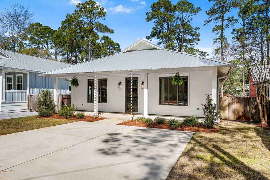 Built in 2022 and located in the Magnolia Beach community, this charming Florida cottage at 1175 E Point Washington Road offers modern finishes and relaxed coastal style just north of Highway 98 in Santa Rosa Beach. The home features classic white Hardie board lap siding, a metal roof, and an inviting oversized front porch, along with a back porch and a beautifully landscaped, fully fenced backyard ideal for outdoor living. Inside, nearly 1,820 square feet of thoughtfully designed living space showcases hardwood floors throughout, an open-concept layout, and tasteful updates at every turn, creating a bright and welcoming atmosphere for both everyday living and entertaining. This single-story residence includes three bedrooms, two and a half baths, and a dedicated office located just off the main living areaperfect for remote work, a playroom, or flexible use. The kitchen serves as the heart of the home with an island, ample cabinetry, appliances, and a walk-in pantry, flowing seamlessly into the spacious living area. The primary suite features a walk-in closet and an en-suite bath with double vanities, a large walk-in shower, and linen storage. Two additional bedrooms share a full bath, while a laundry and coat closet sit conveniently across the hall. Additional highlights include off-street parking for two vehicles, an automatic sprinkler system, and low-maintenance landscaping.

Ideally positioned just blocks from the Choctawhatchee Bay and approximately half a mile from public bay access, this home offers easy access to boating, kayaking, paddleboarding, and fishing. The location is also a short drive to Grayton Beach, Seagrove Beach, and Scenic Highway 30A, placing South Walton's renowned beaches, dining, and shopping within minutes. Nearby Eden Gardens State Park, Grayton Beach State Park, and Point Washington State Forest provide miles of scenic trails and outdoor recreation, making this an exceptional opportunity for a primary residence or coastal retreat in Santa Rosa Beach.