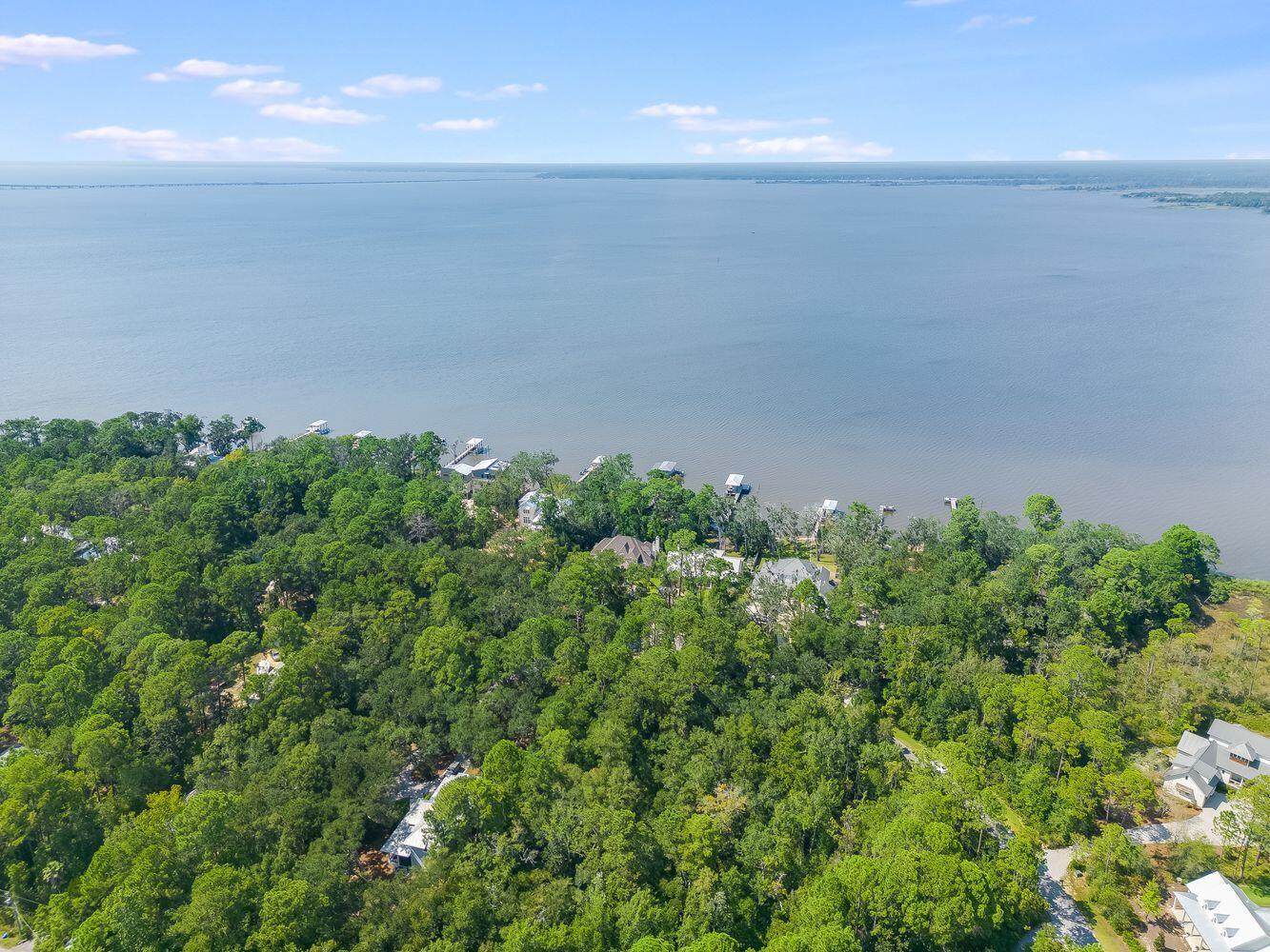 Welcome to Lot 14 Bay Trace! This vacant lot offers a unique opportunity for you to build your dream house in a desirable and picturesque location. Situated in a wooded neighborhood on a cul-de-sac, this .63 acre property provides the perfect canvas for creating your own private oasis.Conveniently located just minutes away from the Seaside beach access, allowing you to enjoy the sun, sand, and surf whenever you desire. Included with the lot are survey, house plans for HOA approved 3954sqft home with over 1600sqft of additional outdoor living space, and wetland survey. The Woods neighborhood also offers a community dock.