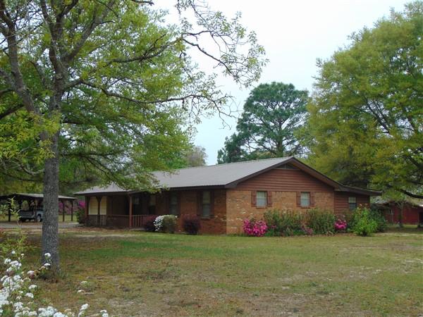 Don't miss out on this great buy on a brick home situated on 1.5 acres S. of I-10. Located just 1/2 mi off Hwy 331 S, you are less than 30 min to the Beaches of S. Walton. This nicely maintained home & lot features include: lot completely fenced; attached garage; detached carport; barn w/ attached equipment parking; garden area; pecan tree, peach tree, blueberry bushes, scuppernongs, numerous beautiful oaks & more. Interior features include: Living room w/ fireplace (chimney has been closed so would need electric or gas insert), 13x34 family room, maple cabinets & breakfast bar in kitchen, 1.5 baths in master. The home is on deep well & septic. Seller has already paid tap fee & meter installed, but not connected, so the option for public water is also available. Metal roof 2011, HVAC 2012.