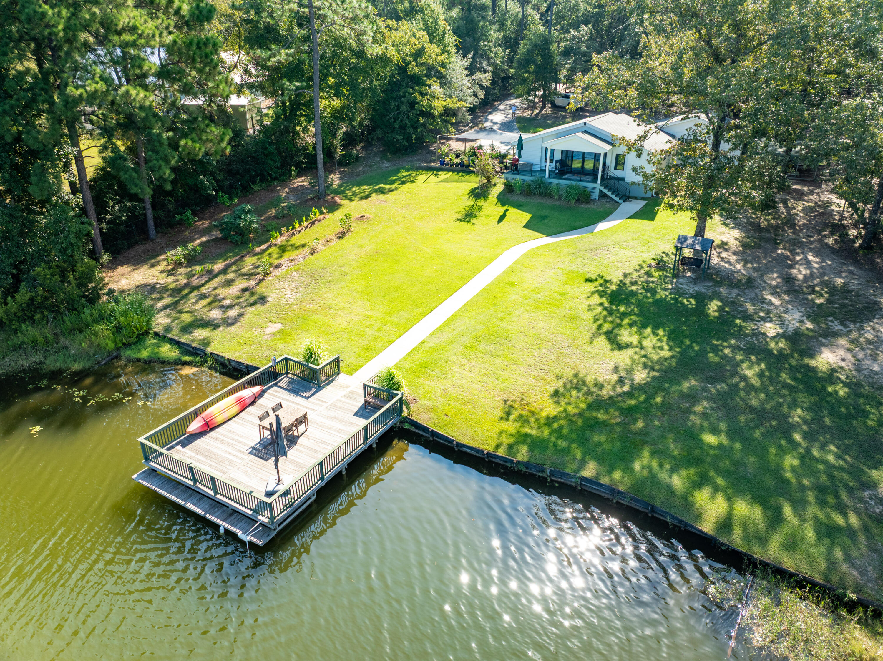NEW LISTING! TURN KEY! Quintessential Lakefront Cottage! Enjoy relaxing weekends on Spring Lake in this charming quality constructed cottage. Designed with unmatched craftsmanship, this retreat features beautiful finishes, energy-efficient spray-foam insulation, and a heated/cooled garage. The lot offers an ideal footprint with sweeping lake views. Seller improvements include an 18' x 20' carport, melamine pantry, reverse-osmosis water system, whole-house sediment filter, electric driveway gate, 20' x 20' garden, 10-fruit trees (figs, grapefruit, plums), and septic cleanout lids for easy maintenance. Perfect as a primary residence or weekend escape--this is true turnkey lakefront living! Showings by advanced appointment.