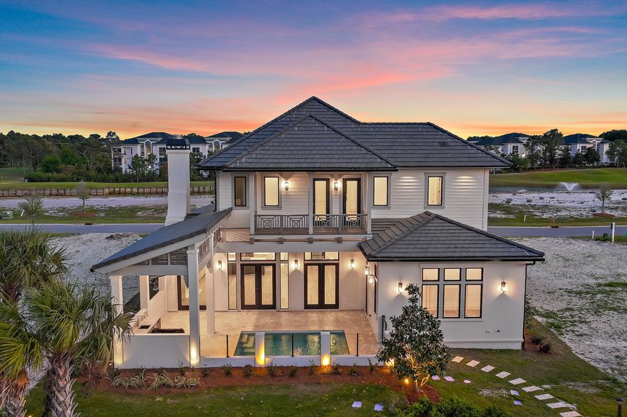 Less than a mile from the beach! Finishes and details are stunning! Introducing Tradewinds, the latest gem in Regatta Bay, featuring 54 exquisite homesites inspired by the architectural elegance of the West Indies and Dutch styles. This stunning, brand-new residence embodies modern luxury, seamlessly blending indoor and outdoor living across over 3,600 square feet of climate-controlled space. It boasts 4 bedrooms, 4 full bathrooms, and an additional half bath. The exterior showcases an inviting outdoor area, complete with a summer kitchen and a picturesque Alys Beach-style pool, making this home an ideal retreat for relaxation and entertainment. Click more for additional information. Upon entry, you are immediately captivated by the design, featuring wood beams on the ceiling and gracefully curved arches. The home presents a sophisticated black-and-white theme, enhanced by tasteful tile selections in the kitchen, butler's pantry, wet bar, and bathrooms. The home boasts an inviting open floor plan, highlighted by a spacious living room featuring a cozy fireplace and a gourmet chef's kitchen equipped with top-of-the-line amenities. On the first floor, the master bedroom provides breathtaking views and direct access to the outdoor living area. The master bath showcases double vanities, elegantly designed lighting fixtures, a custom walk-in tiled shower, and a luxurious soaking tub. Adjacent to the master bedroom, a generous walk-in closet offers custom shelving and his-and-her drawers for added storage. Also located on the first floor is a convenient powder bath for guests, a wet bar, and a guest suite complete with its own private bath. Upstairs, you will discover a generous bonus room, an extra wet bar, two guest suites each featuring private baths, a sizable storage or multipurpose room, and an expansive balcony. Built by Legendary Home Builders, utilizing only the finest materials and high end finishes such as: wind and impact resistant windows, wind and impact rated doors, insulated wind and impact rated garage doors, insulation in all interior walls for energy efficiency, sound proofing insulation between floors for sound barrier, stainless steel door hinges, custom wood shelving in all closets, Kohler plumbing throughout, custom solid wood cabinetry throughout with soft close hinges, surround sound, smart home technology customizable for homeowner, led lighting throughout and so much more...