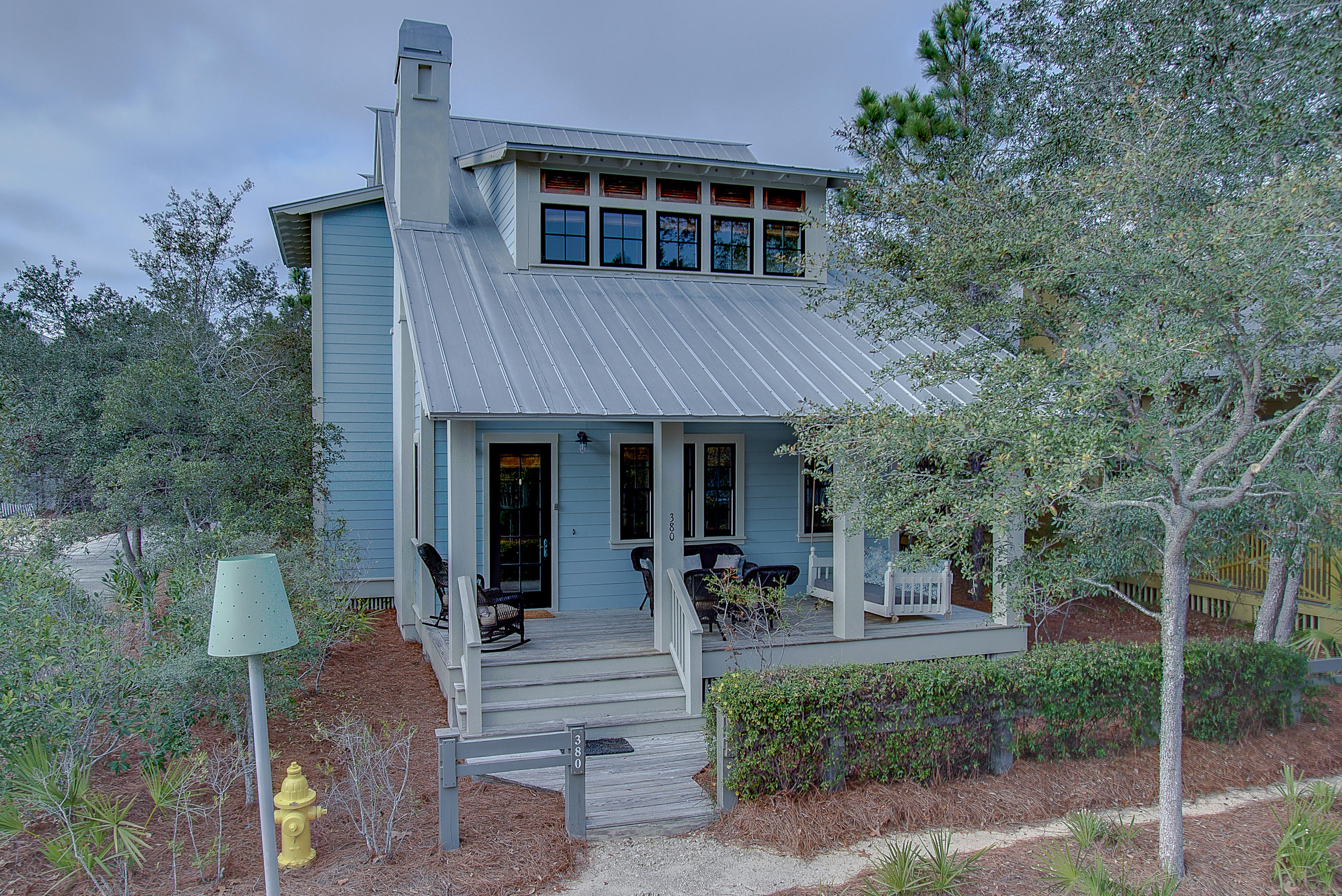Incredible custom home designed by Duncan-Nequette Architects and built by Velvet Sun Builders nestled across the street from Woodfern Park and Camp Watercolor. Situated on a corner lot, this beautiful 4 bedroom home plus carriage house and 2 car garage sleeps 15 people comfortably. With an open living concept, this builder's personal home includes 3 fireplaces, 3 porches of which 2 are screened in, and Subzero and Wolf appliances. The tongue and grove walls and ceilings and heart pine floors and beams add warmth and character throughout the house. This home has a proven rental history and is projected in 2017 to bring in 100k in rental income. It easily accommodates 2 families and has been a long time favorite of many repeat guests. For more details, please see the attached supplement. Each of the four bedrooms have televisions and a full bathroom and closets with ample storage space. Master bedroom located on the second floor has a brand new king upholstered bed, a large walk-in closet and a linen closet. The bathroom has separate vanities, a large walk-in shower with multiple shower heads and a beautiful claw foot tub. The large screened porch located off this room and equipped with a fireplace further enhances the tranquility of this master suite.

The second master is located on the second floor and is very generous in size. It has a king bed and a beautiful bathroom with the shower equipped with a spa-like rain shower head.

The third bedroom, also located on the second floor, consists of three built-in bunk beds with TVs, two closets, and a full bathroom.

There is a cozy TV area on the second with a pull-out sofa which will easily accommodate two children or one adult. This area is the perfect place for children to gather when they need a little space of their own.

The kitchen and dining area are open and inviting for large groups. The table easily seats 8-10 and the kitchen island has two stools providing two more seats.

There is also a bedroom located on the first floor. It has a king bed and a full bathroom with a walk-in shower.

On the front of the house, there is an expansive porch with a cozy bed swing and lots of other seating options. On the back of the house, there is another screened porch with a grill, fireplace and a table to enjoy meals and congregation.

The house boasts a gorgeous carriage house over the two car garage. There is a complete kitchen, large bathroom with walk-in shower, three closets for ample storage, a king bed, and a set of bunks with a trundle accommodating up to five people.

This home is perfect for any family or easily accommodates two families with its ability to sleep 14-15 people comfortably. This home has strong rental history and projections and has been a long time favorite of many repeat guests especially since it can typically handle two families.

As the home was built for the builder, it is charming, unique, and built with all the special touches and high quality finishes you would expect with a builder's personal home. Whether you spend your days reading on one of the three porches or find yourself rinsing off at the outdoor shower after a long day at the beach, this beautiful home will surely live up to it's name, Making Memories.